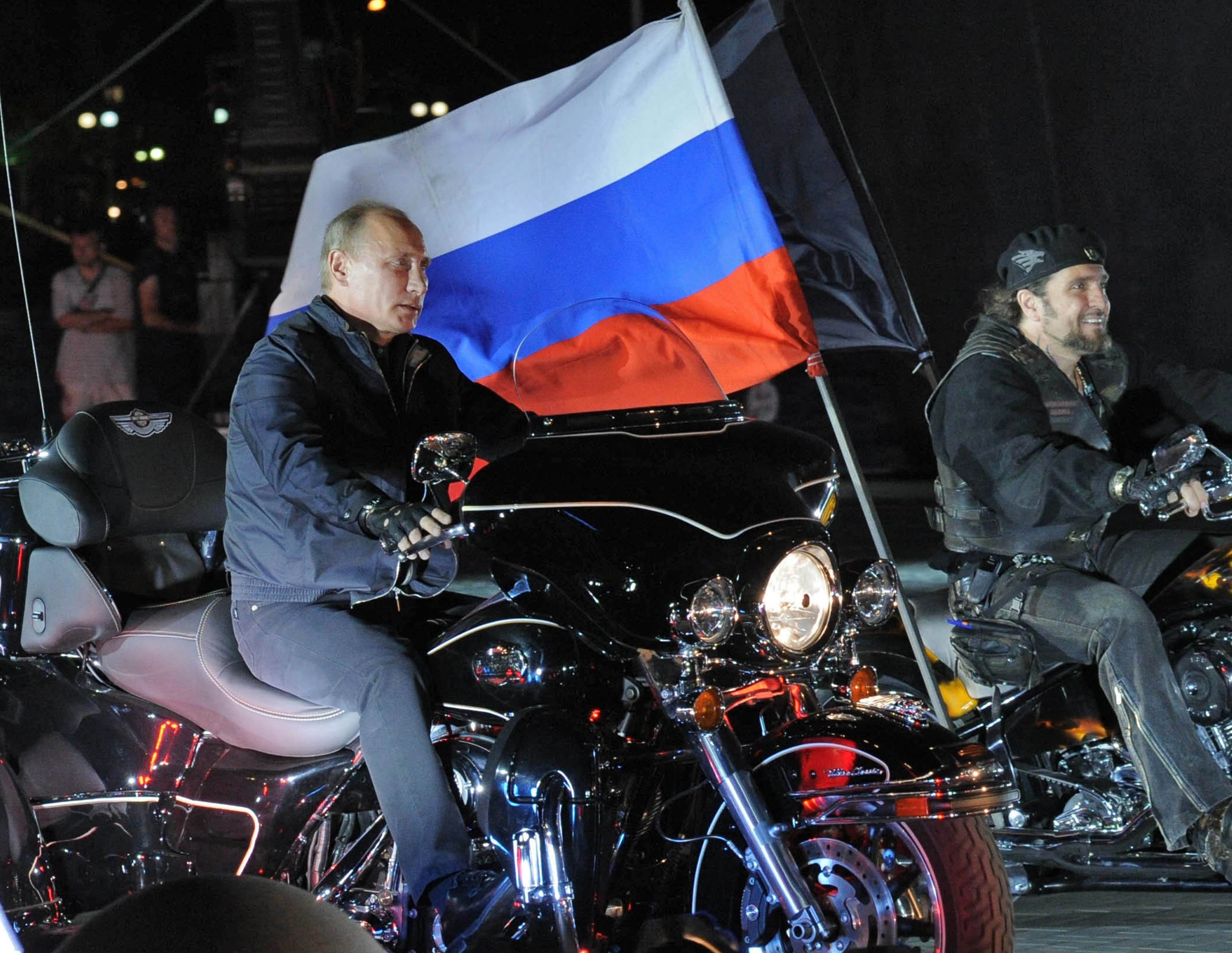 Russian President Vladimir Putin rides alongside Night Wolves leader Alexander Zaldostanov, at a rally in Novorossiysk in 2011