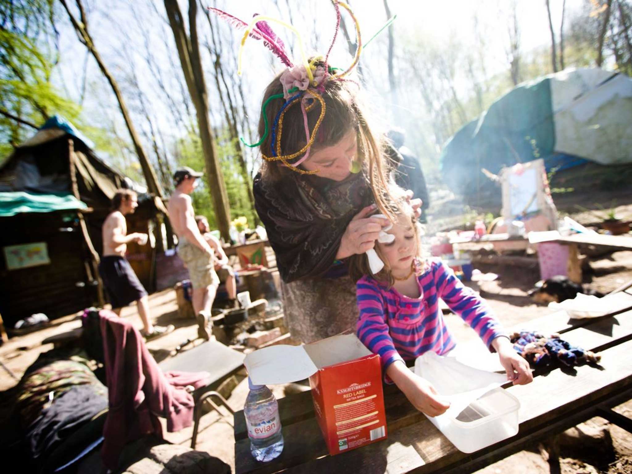 Free cleans her daughter, Rosie, at the squatter camp established in June 2012 – they may have to up sticks