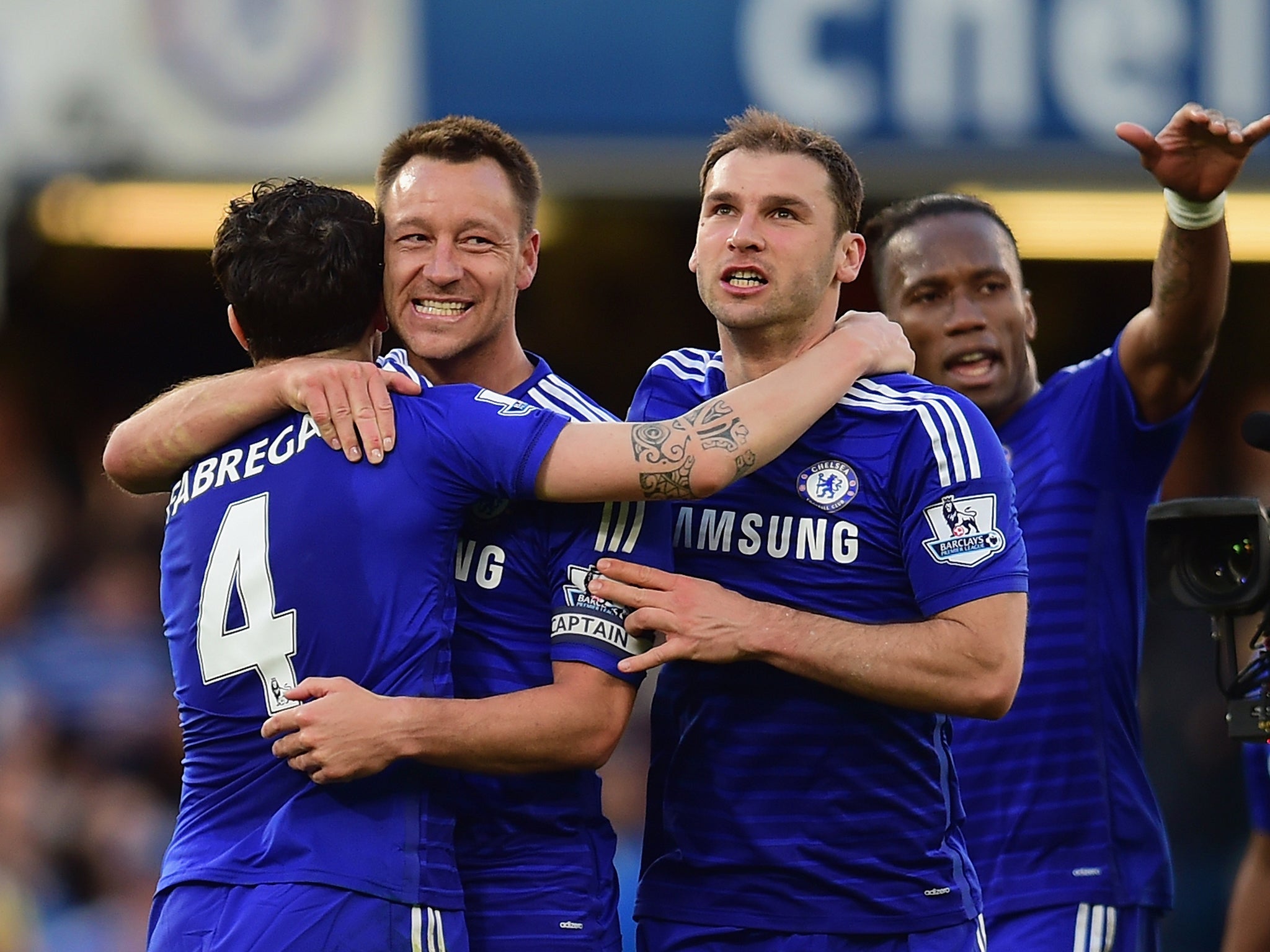 Cesc Fabregas hugs John Terry and Branislav Ivanovic after victory over United