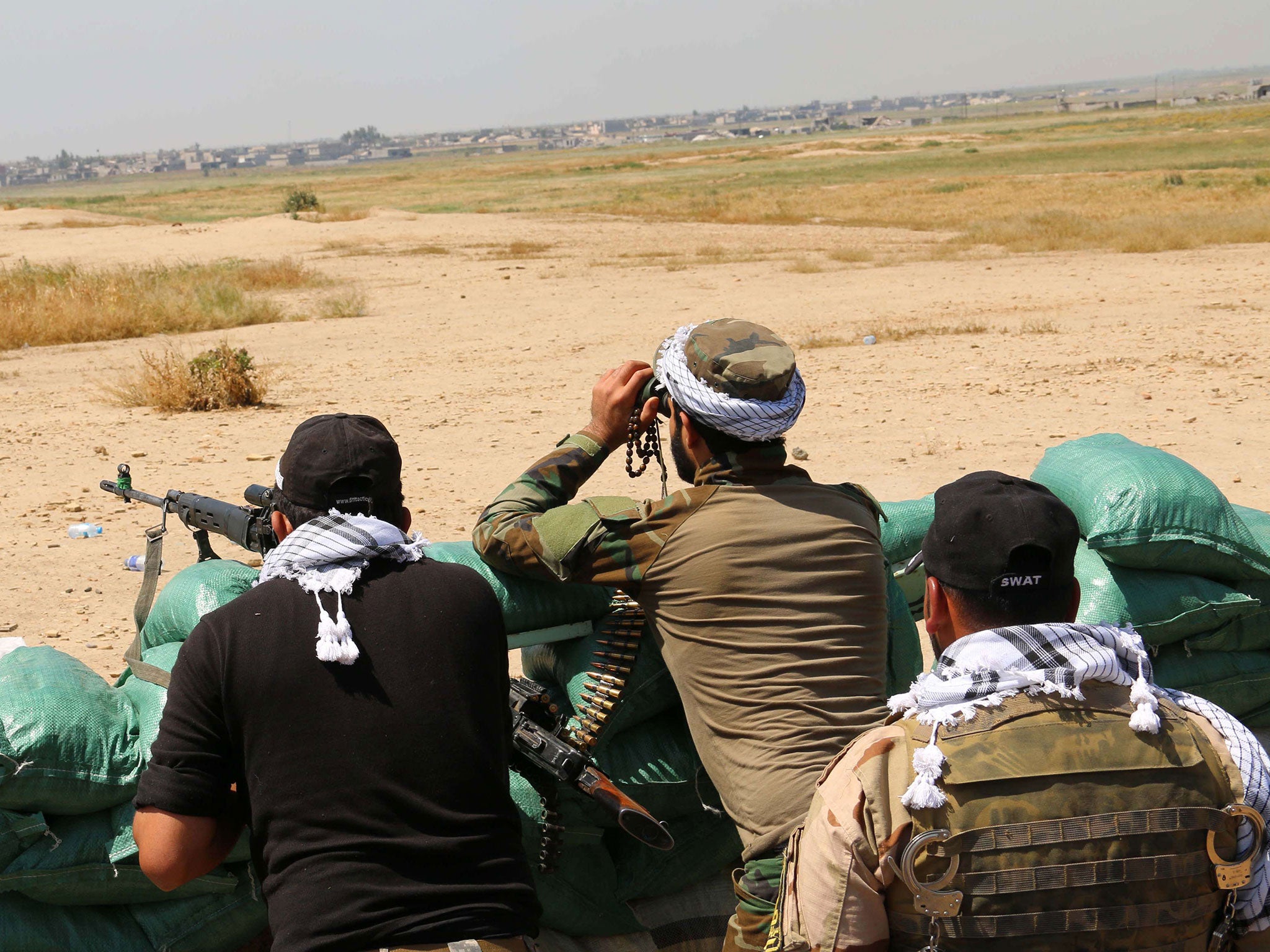 Kurdish Peshmerga forces and al-Hashd al-Shaabi factions hold a position close to the village of Bashir south of Kirkuk at the weekend as they launch an operation to recapture villages from Isis