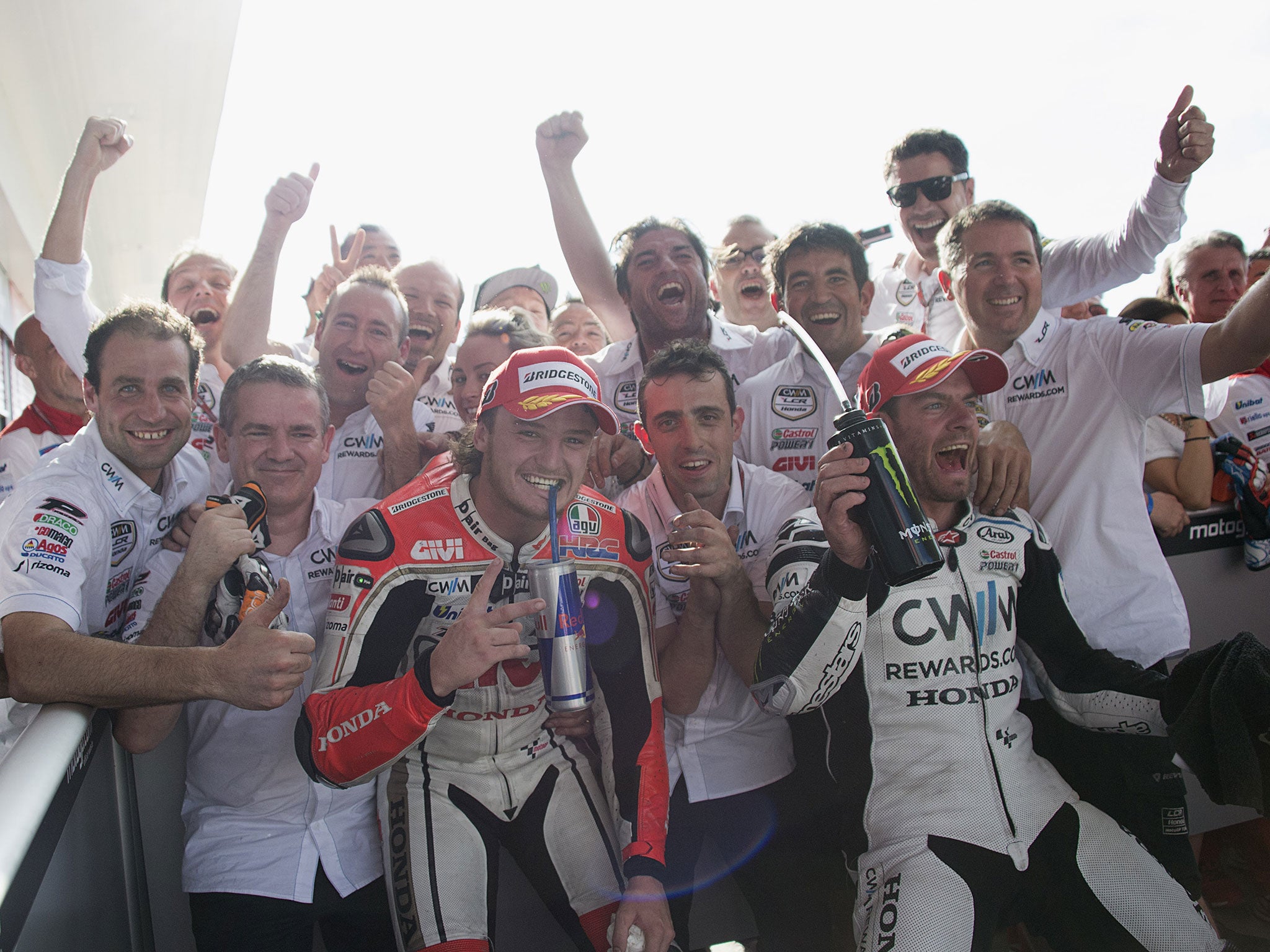 Cal Crutchlow (right) celebrates with Jack Miller and his LCR-Honda team