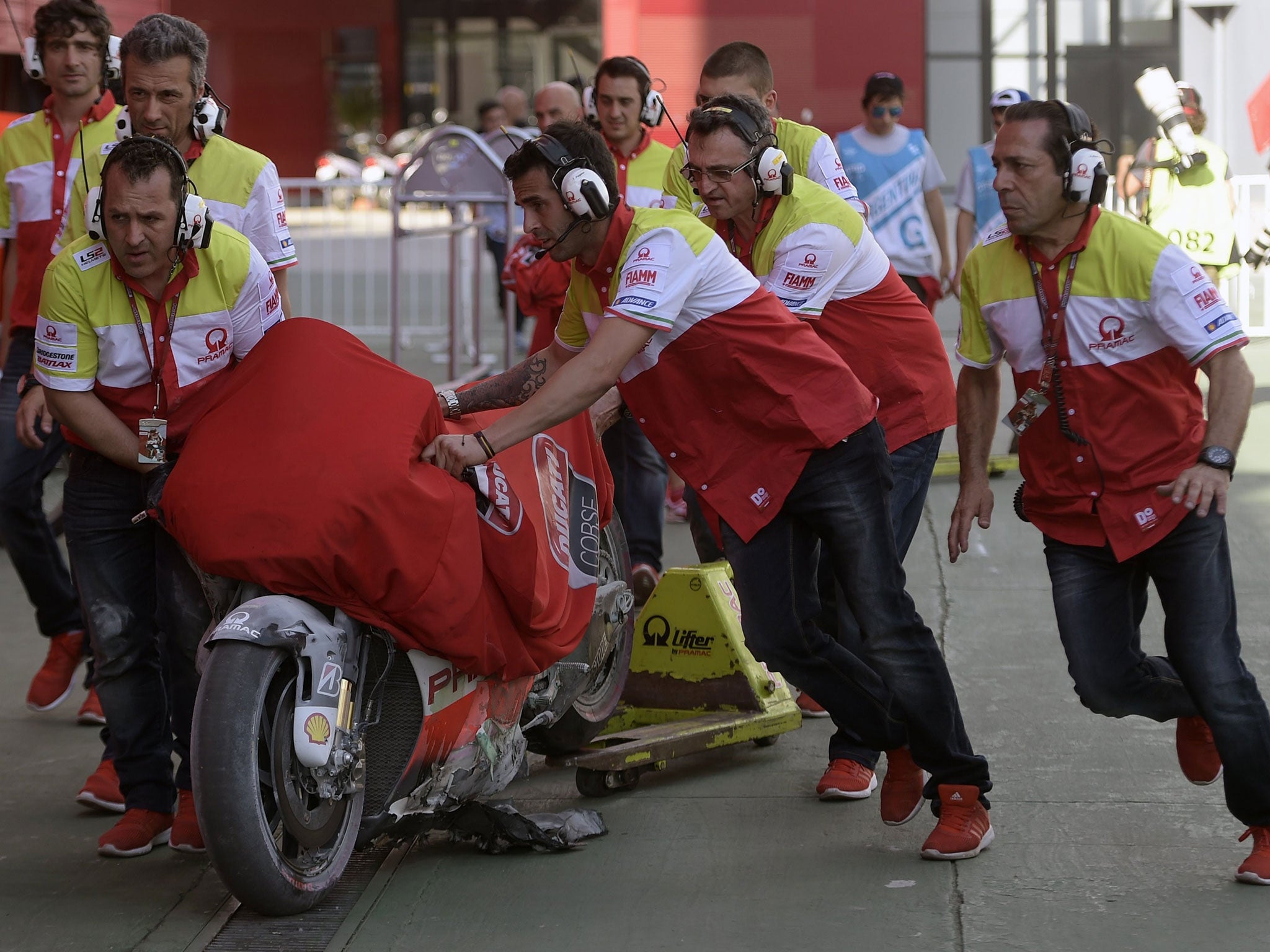 The burnt out Ducati of Yonny Hernandez is retrieved to the pits