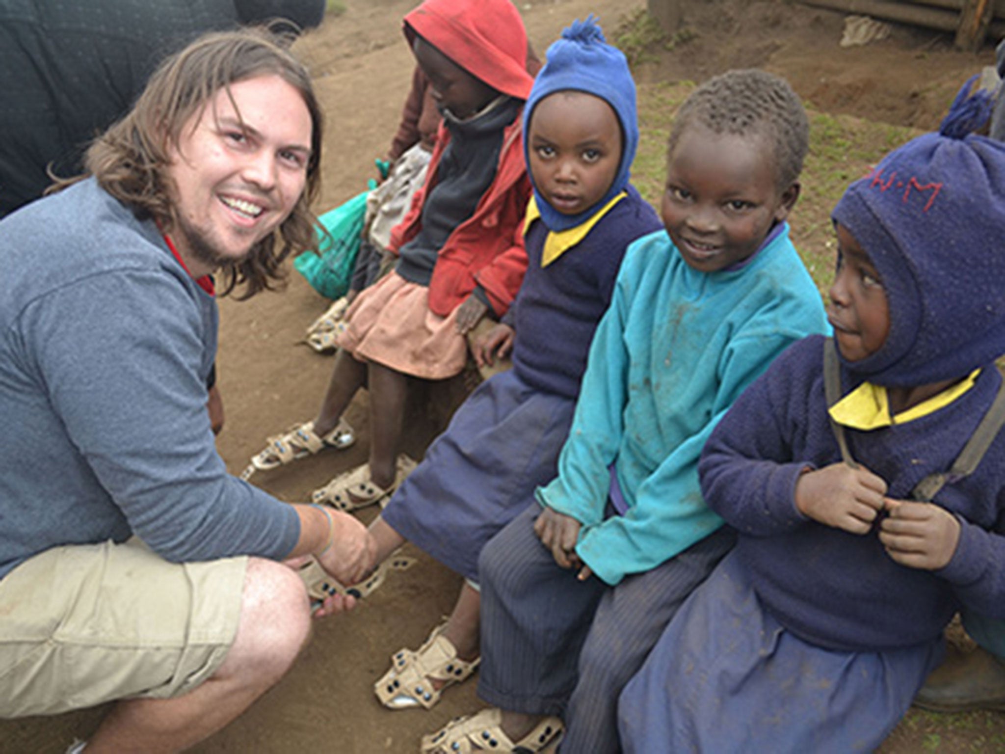 Founder and Executive Director Kenton Lee distributing the shoes