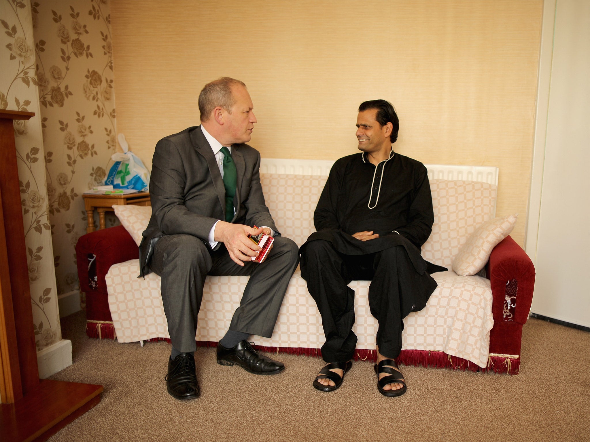 Simon Danczuk is invited inside for a chat with local resident Nasir Mahmood (Getty)