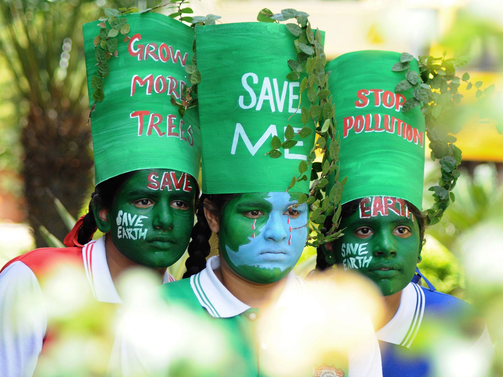 Young Indian girls pose with their painted faces during a 'Save Earth' awareness programme on the eve of World Earth Day at a school in Patiala on April 21, 2015.