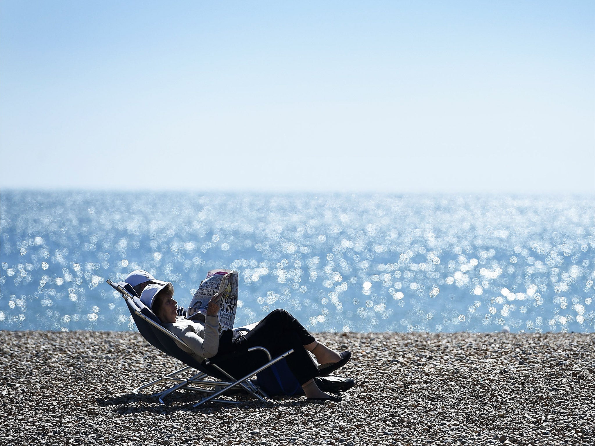 A couple sit on Brighton beach - in Caroline
Lucas' constituency - earlier this week during unseasonably hot weather