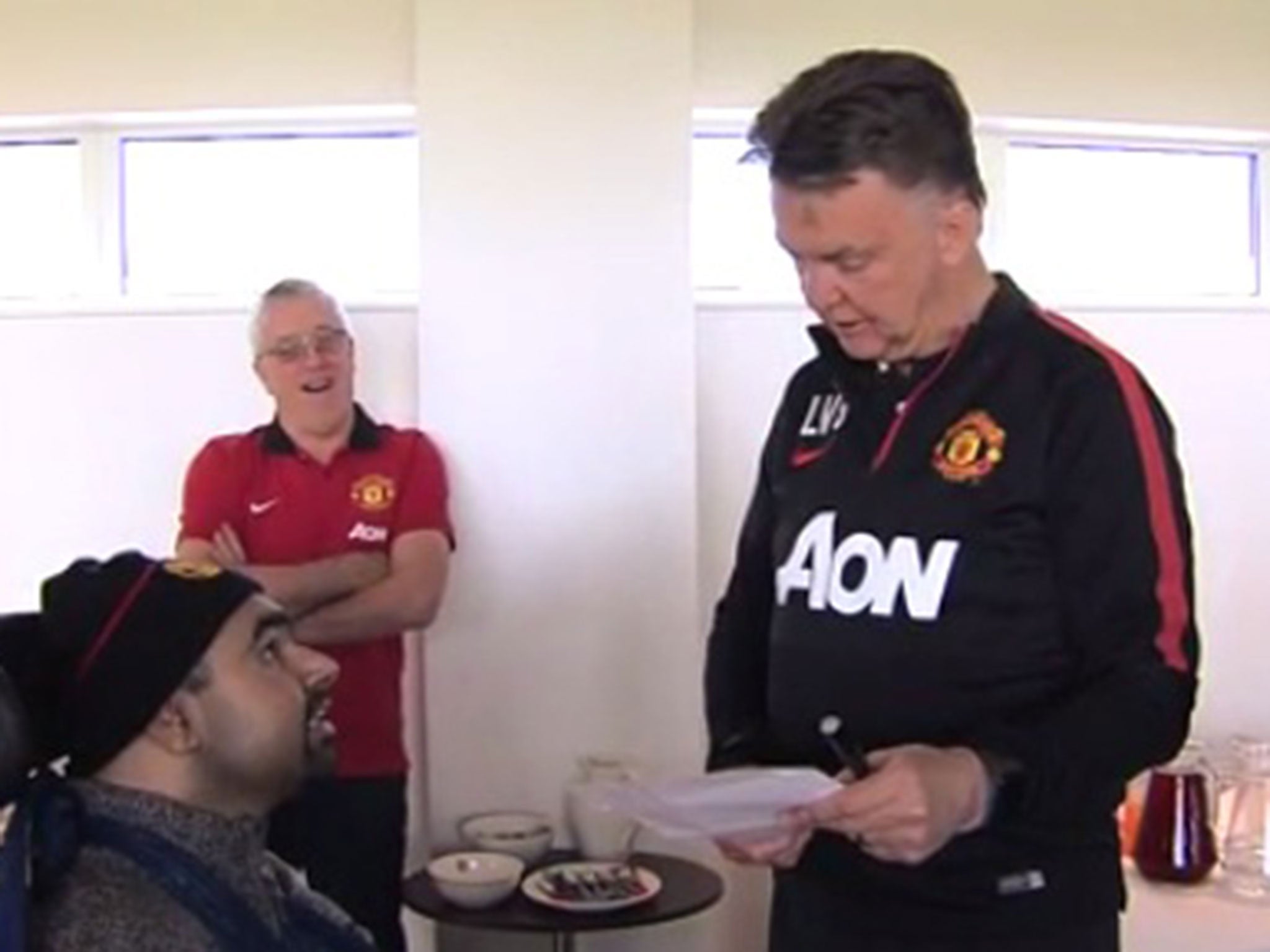 Louis van Gaal is handed the transfer wishlist from the fan