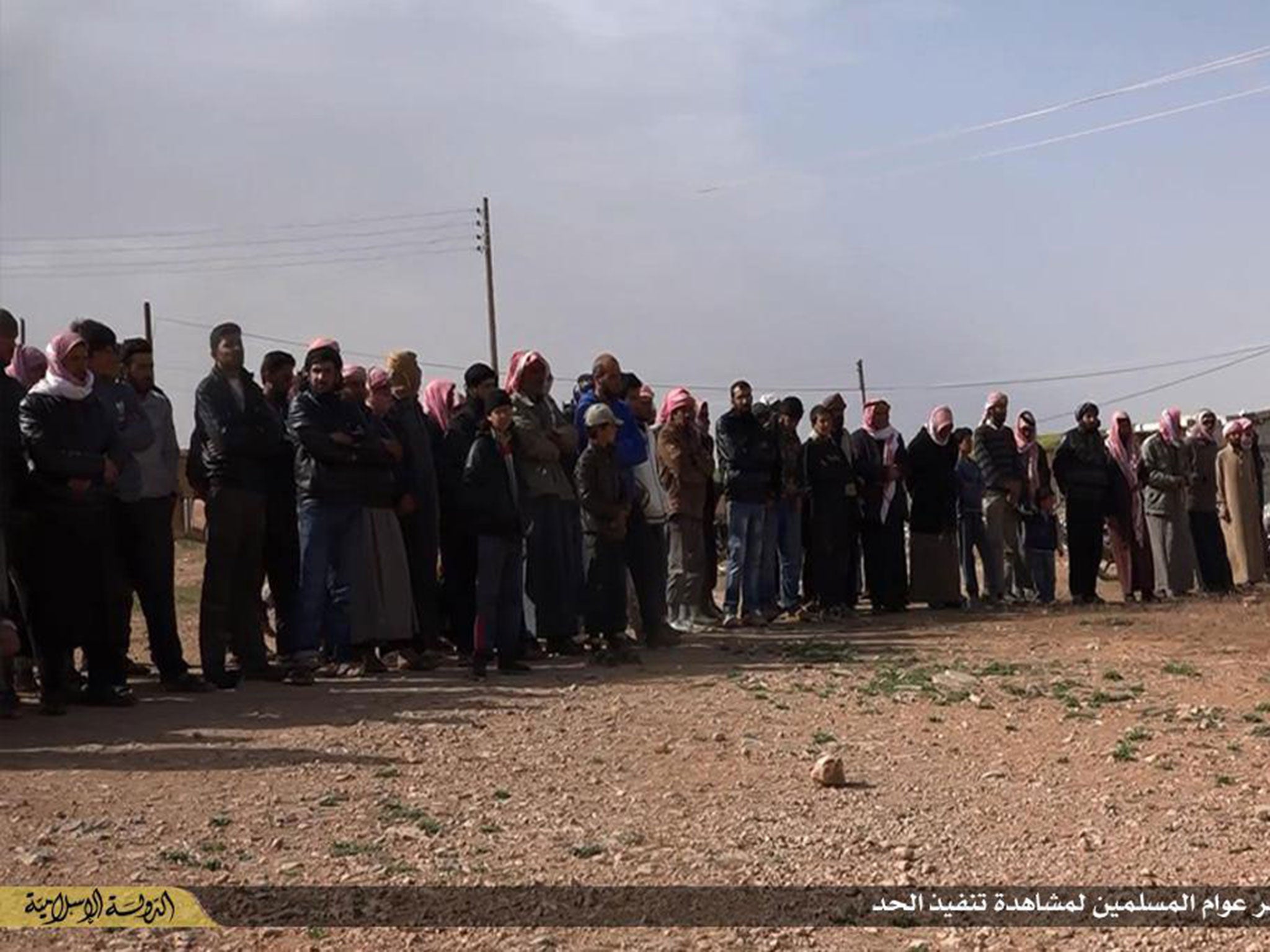 Crowds gather to watch the men as they are stoned to death