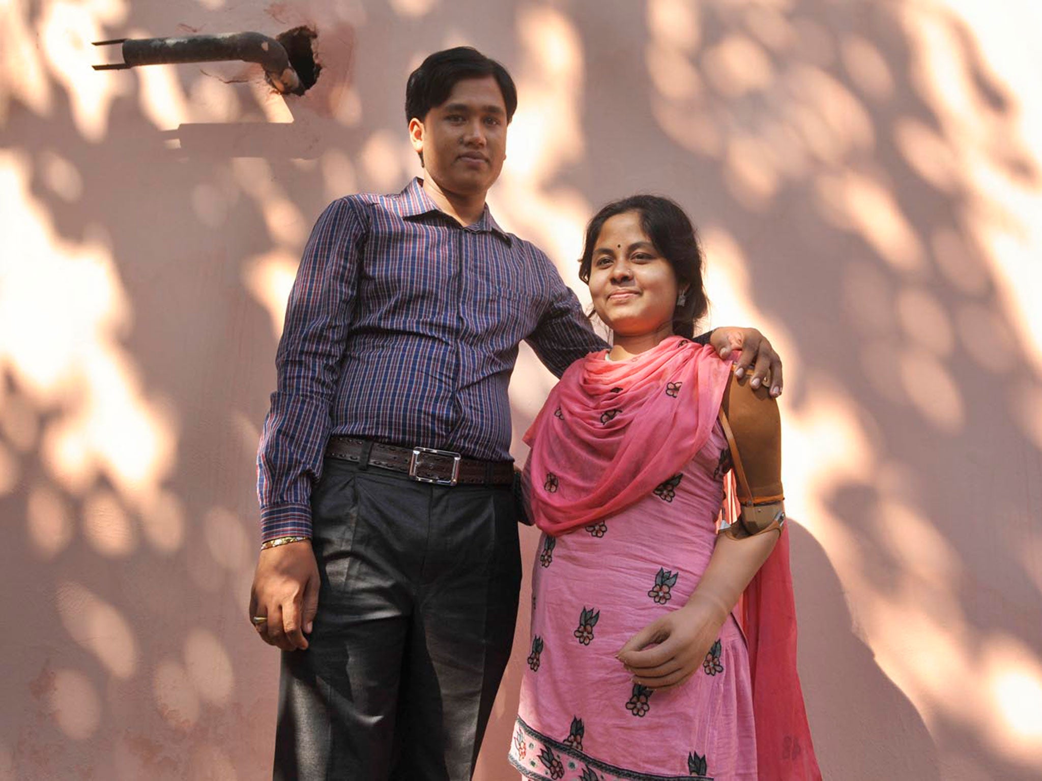 Garment worker Laboni, stands with her husband, she lost her left hand at Rana Plaza collapse © Khorshed Alam Rinku