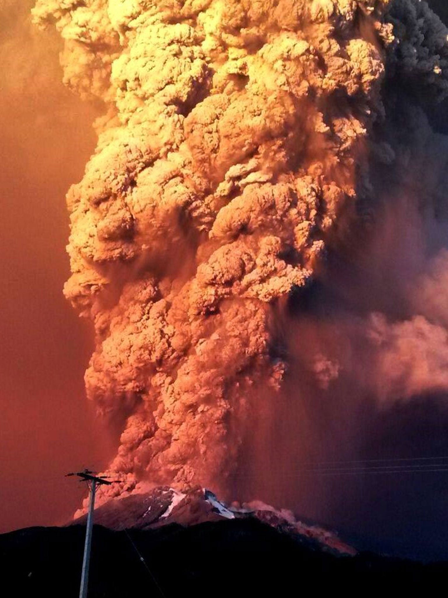 View from Puerto Varas, southern Chile, of a high column of ash and lava spewing from the Calbuco volcano