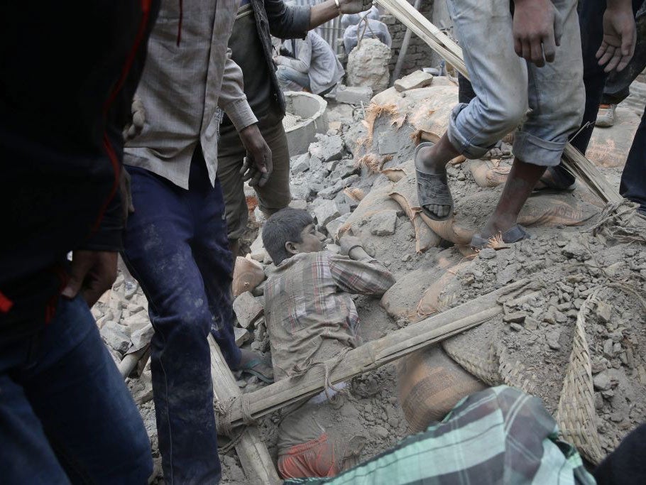 A man struggles to free himself from under the rubble of a destroyed building