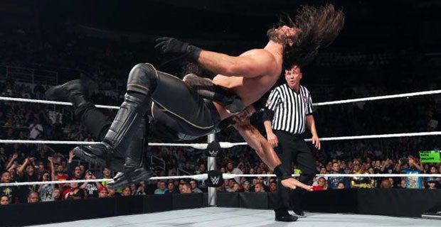 Roman Reigns hits Seth Rollins with the spear