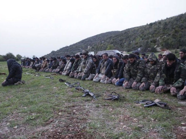 Rebels praying in the countryside on 20 March as they headed towards Jisr al-Shughour