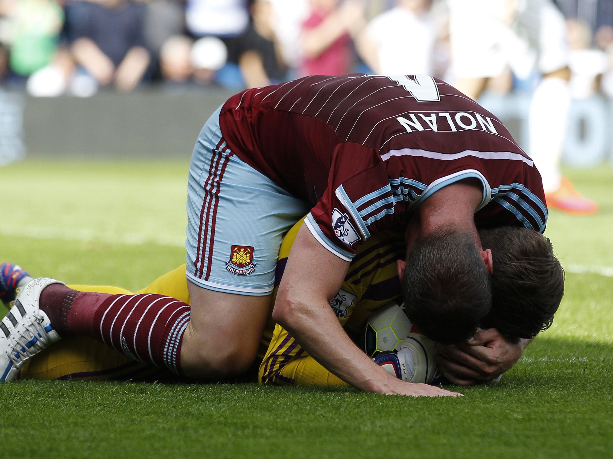 Kevin Nolan dives on Adrian to celebrate his penalty save