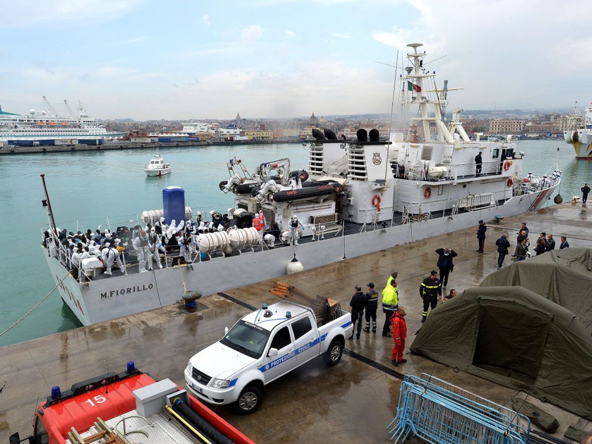 Migrants wait to disembark in Catani