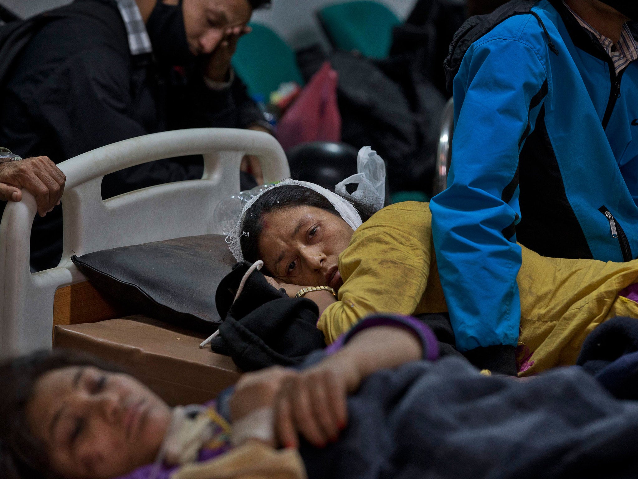 An earthquake injured woman lies at a hospital in Kathmandu