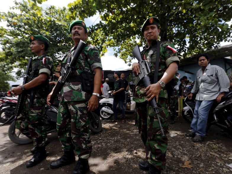 Indonesian soldiers stand as guard at Wijayapura port near the prison island of Nusakambangan on Monday