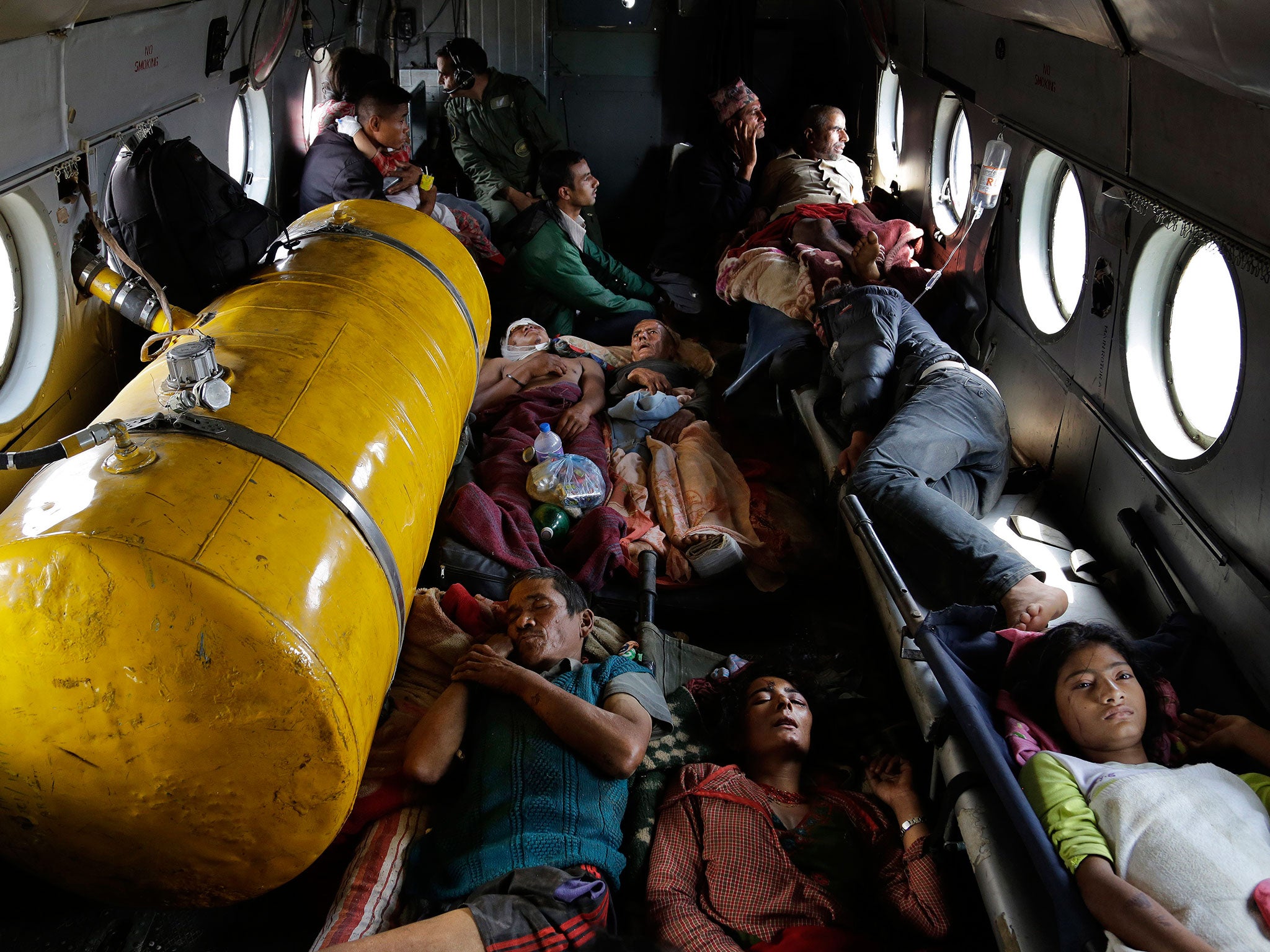 Nepalese victims of the earthquake lie inside an Indian air force helicopter as they are evacuated from Trishuli Bazar to Kathmandu airport in Nepal