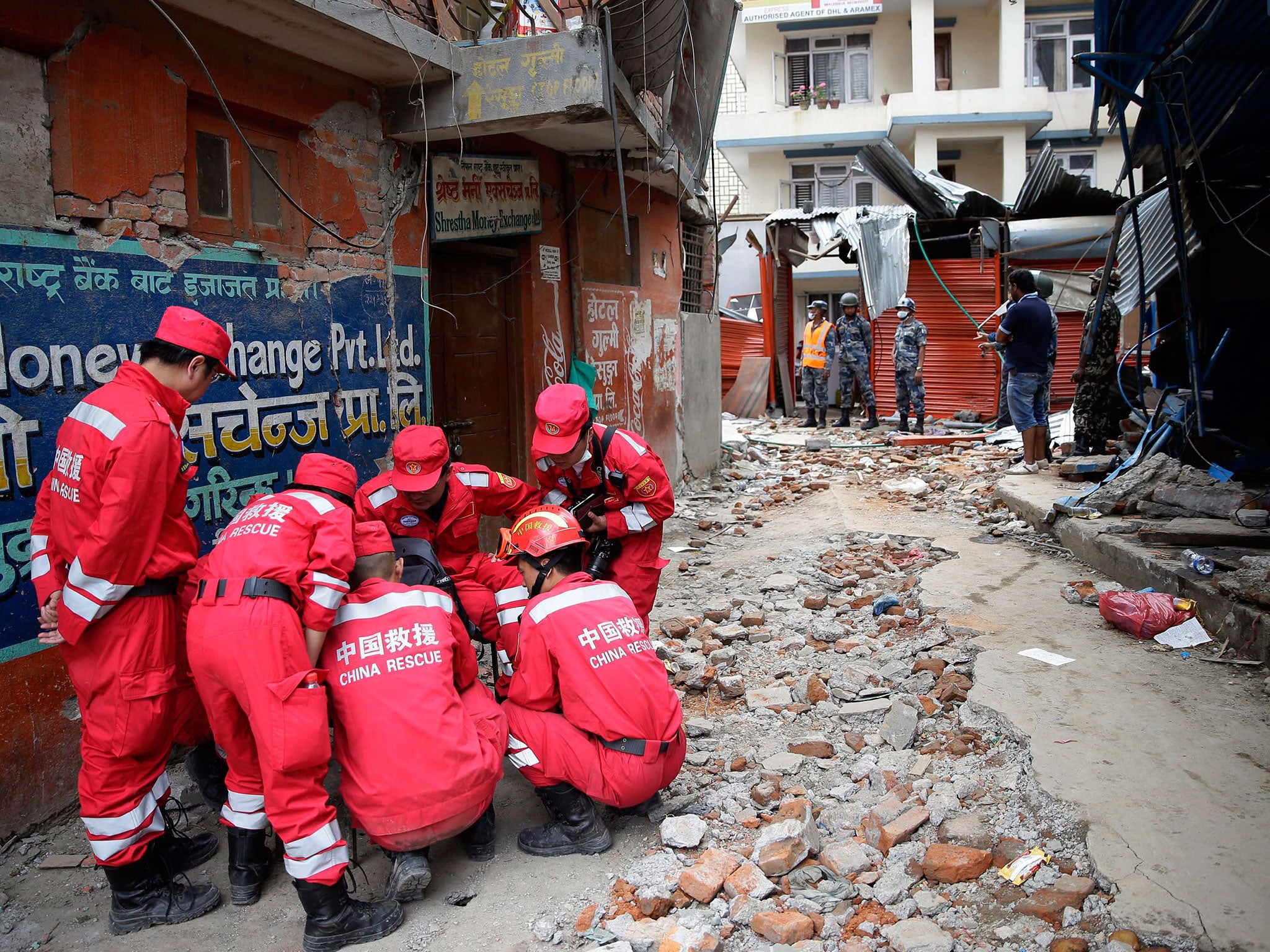 Members of a rescue team from China huddle while planning their operation at the site of earthquake in Kathmandu