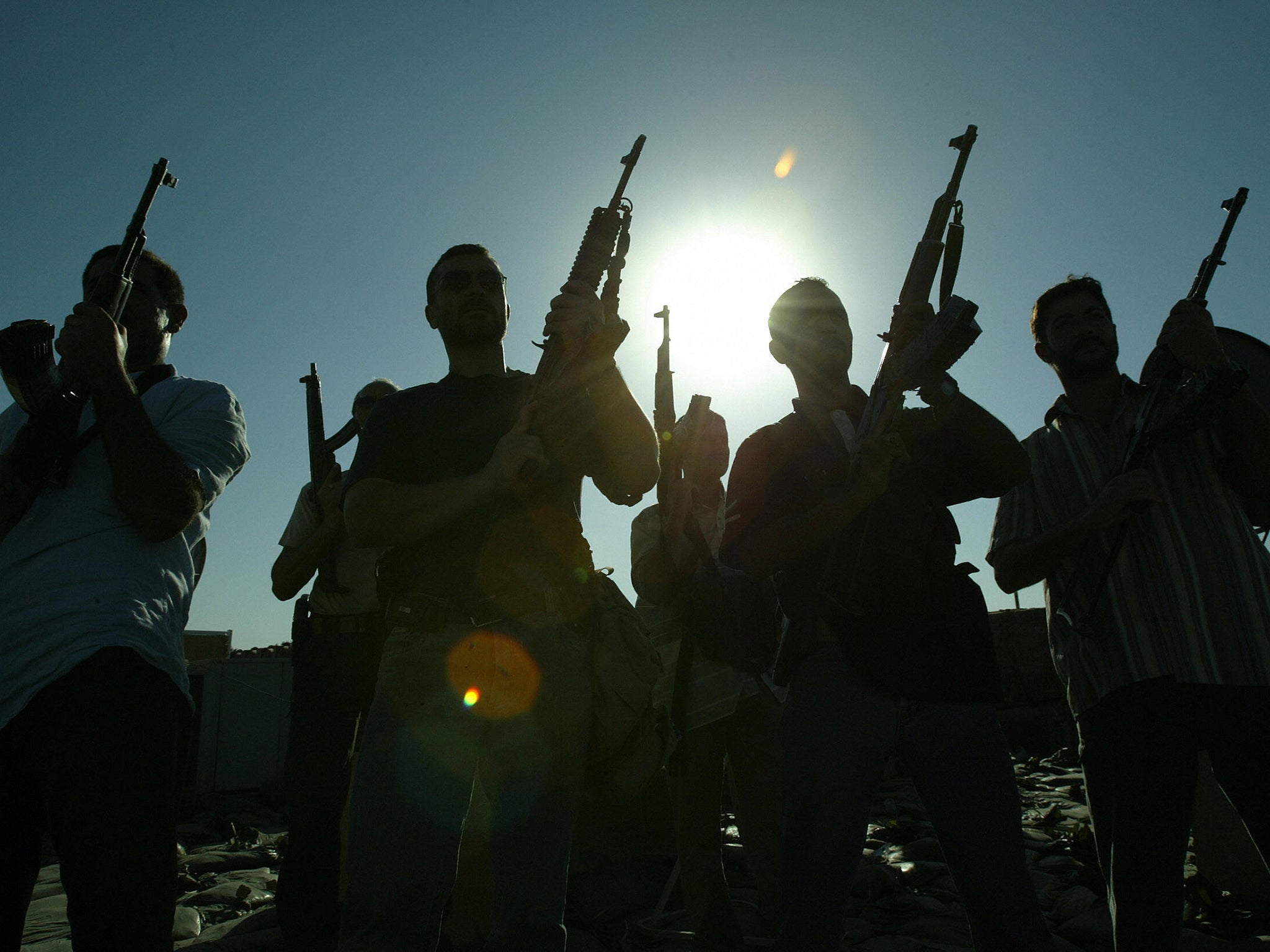 Members of a private security company pose on the rooftop of a house in Baghdad in 2007