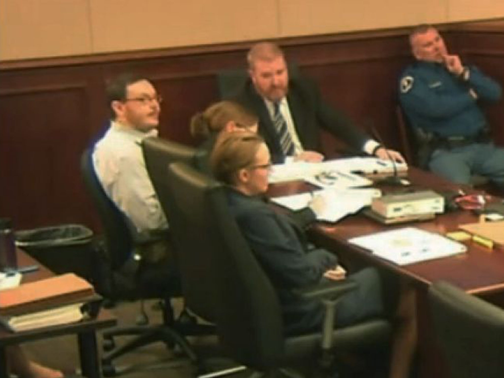 James Holmes, far left, sits at the defence table at the opening of his trial in Colorado on Monday