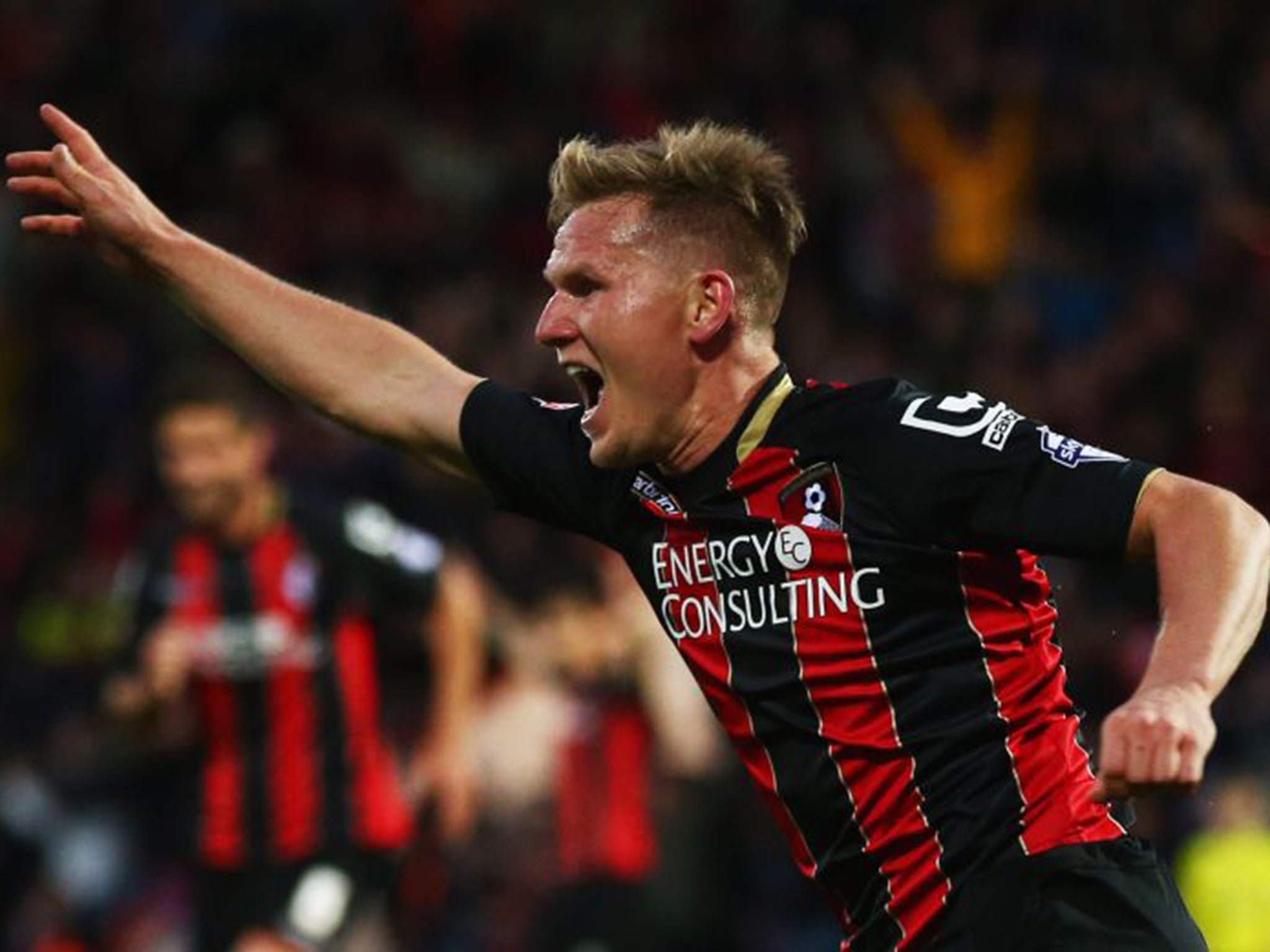 Matt Ritchie wheels away in triumph after scoring the second goal for Bournemouth against Bolton last night