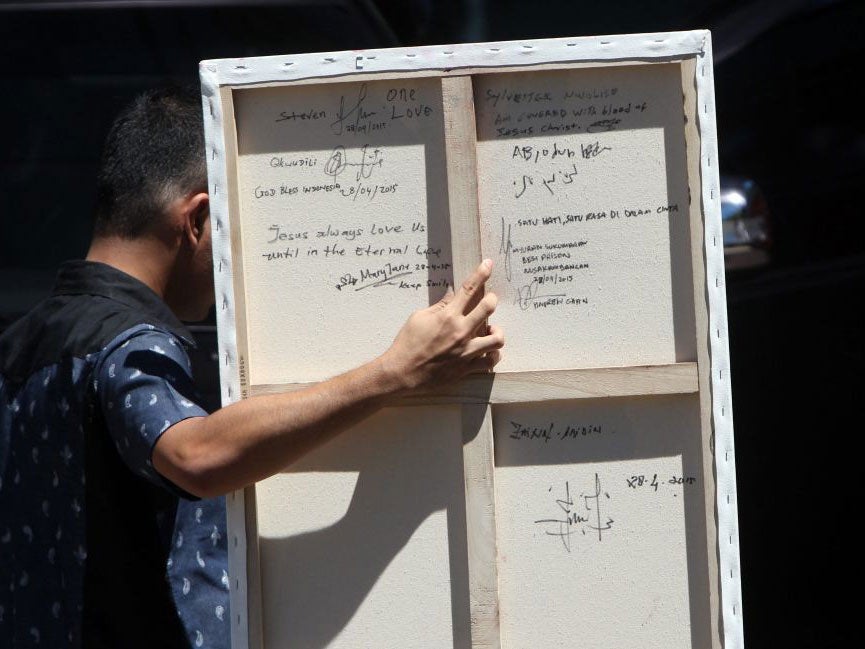 The back of a painting by Australian death-row prisoner Myuran Sukumaran is shown, signed by the eight other condemned people