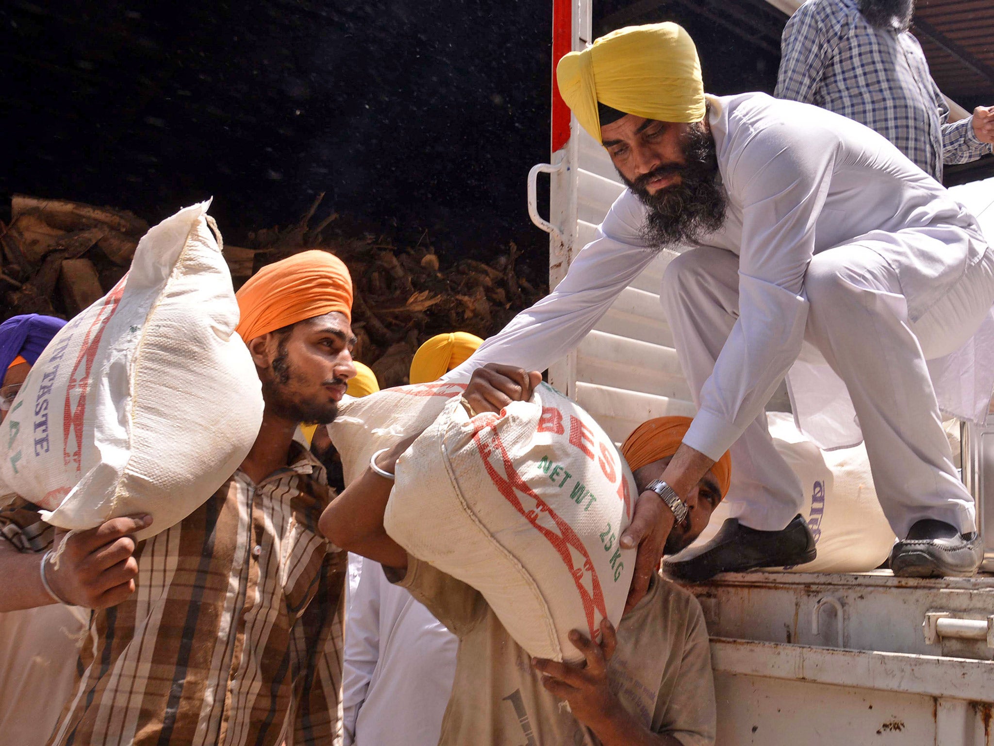 Volunteers load relief material for Nepal in Amritsar, India