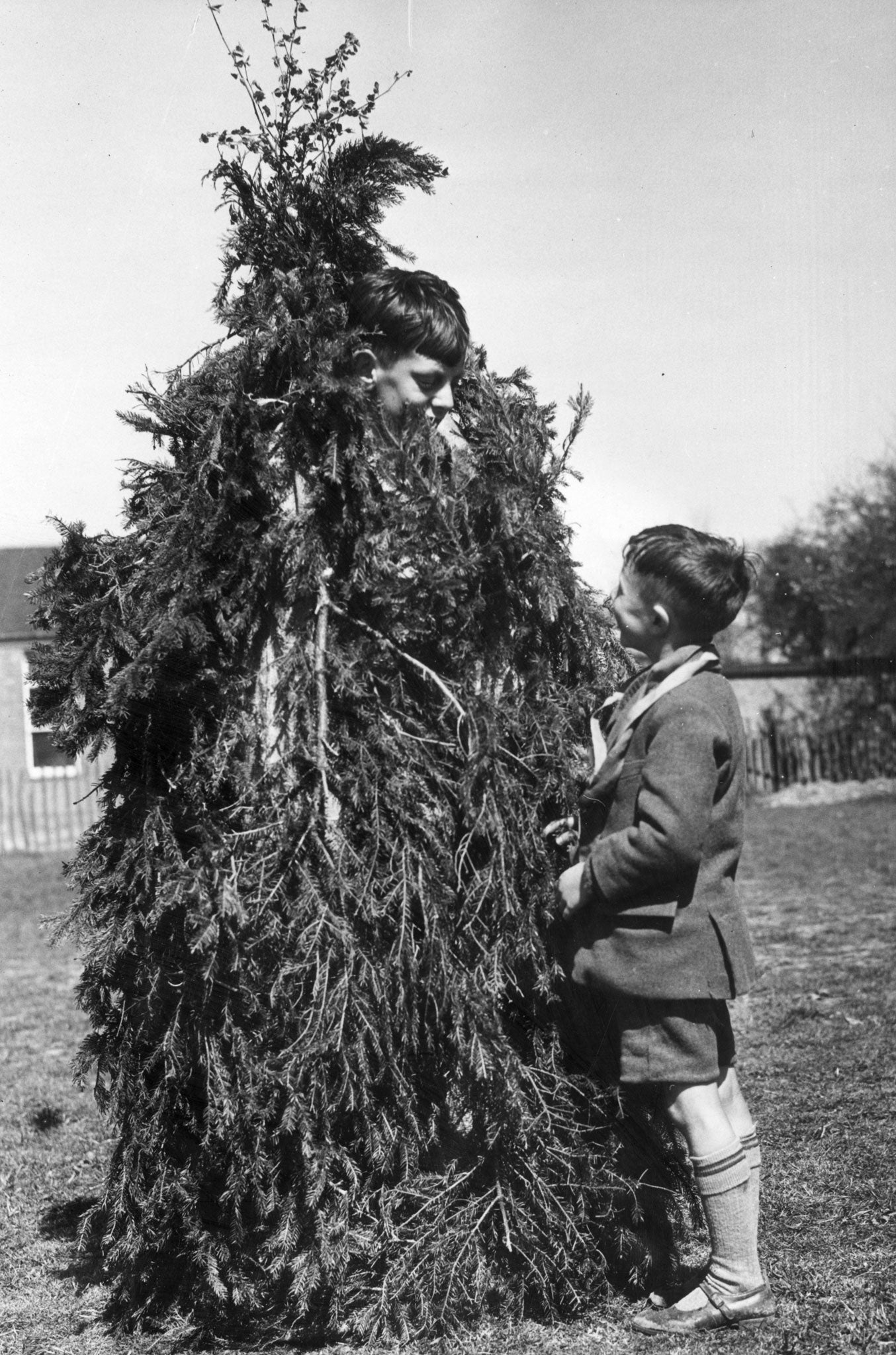 A schoolboy dressed up as the mythical character before a folk dance in Kent, 1942