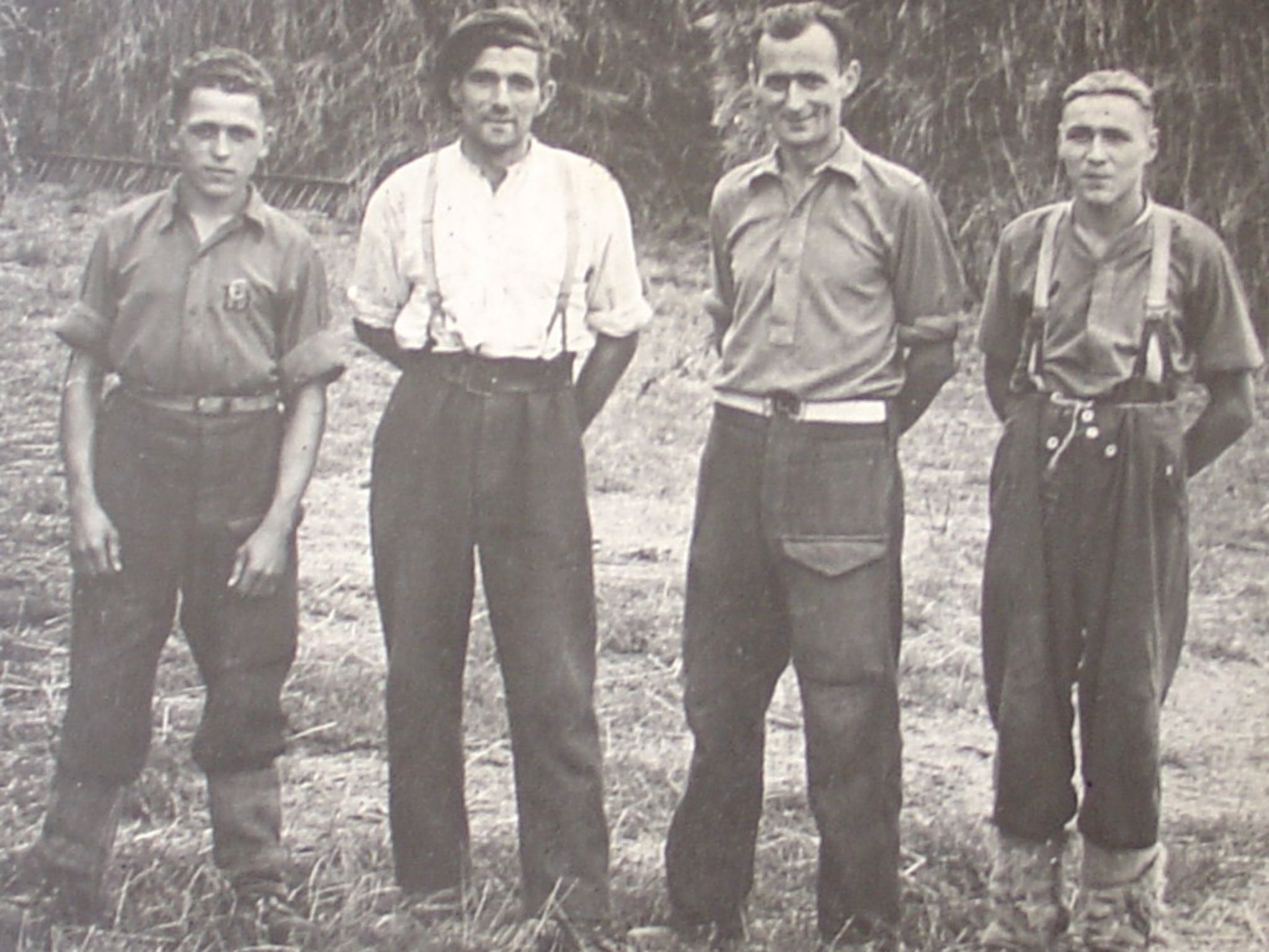 Survivor: Eberhard Wendler, left, a British farm worker and two other POWs in
1945