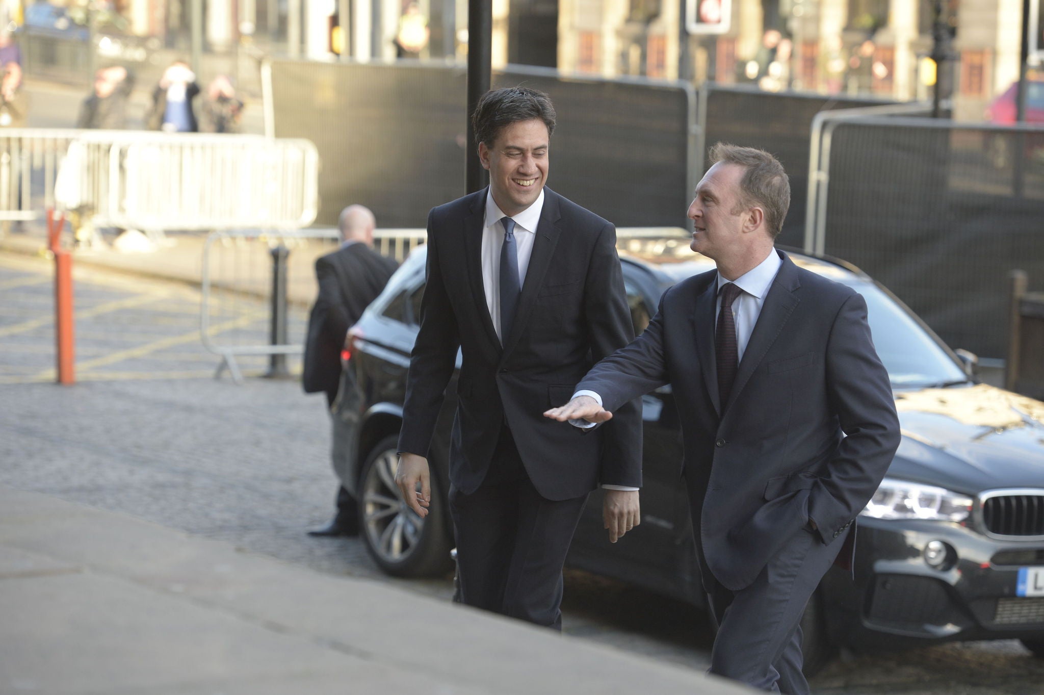 Ed Miliband is guided up the steps at the Leeds Art Gallery