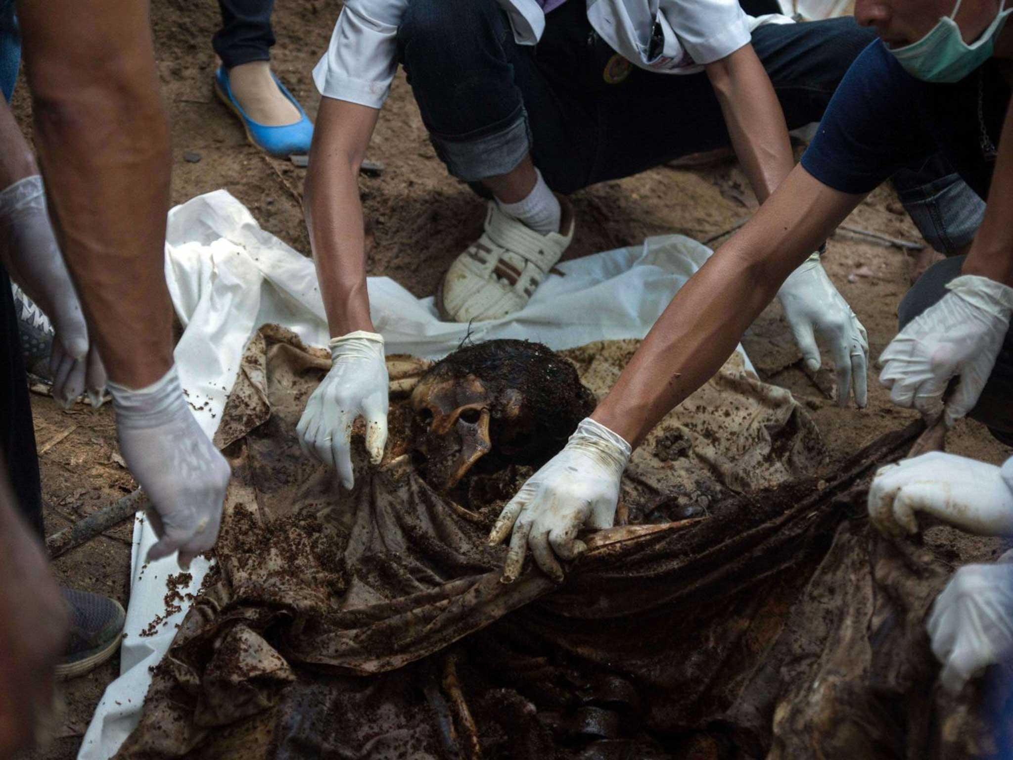 Forensic teams examine one of the bodies