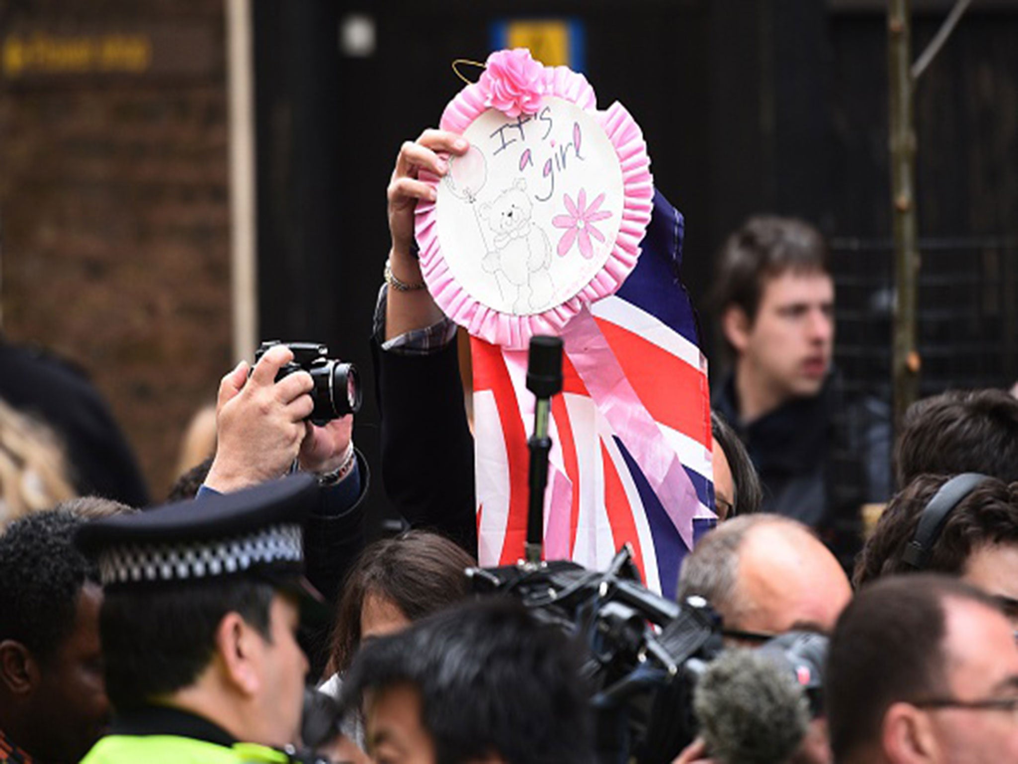 Members of the public celebrate the arrival of a baby girl