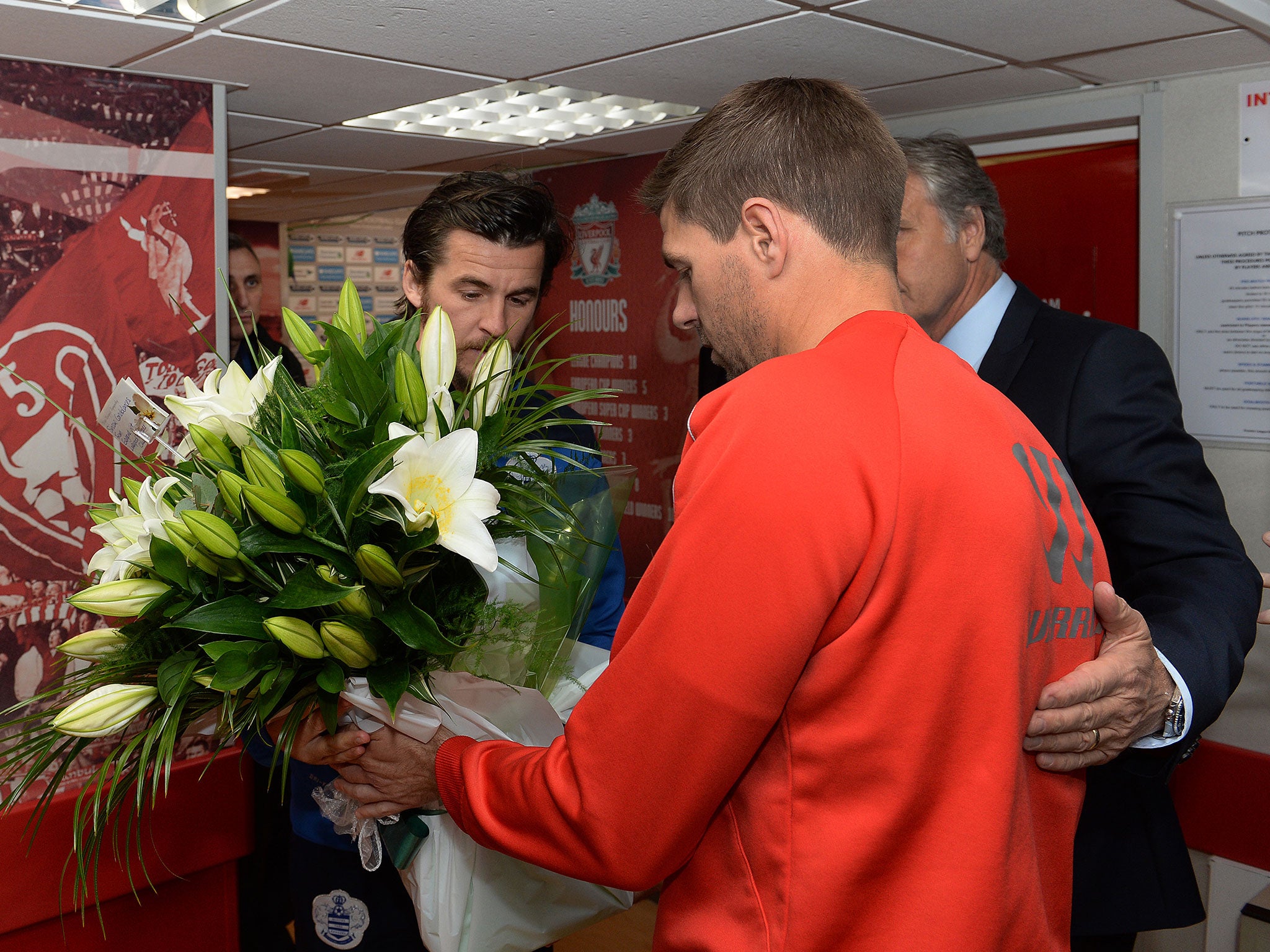 Gerrard presents Barton with a bouquet of flowers