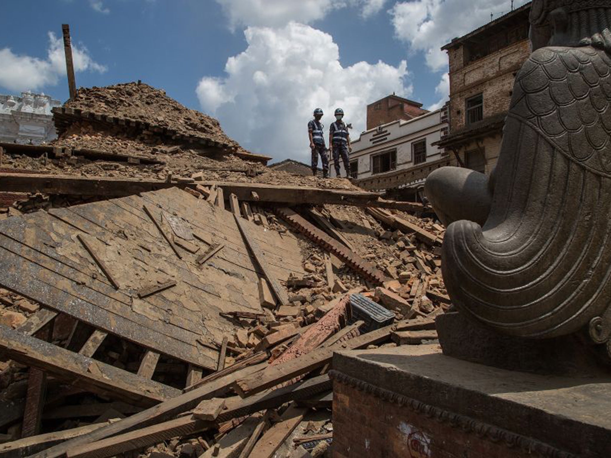 Rescuers look down on debris at Basantapur Durbar Square in Kathmandu last week