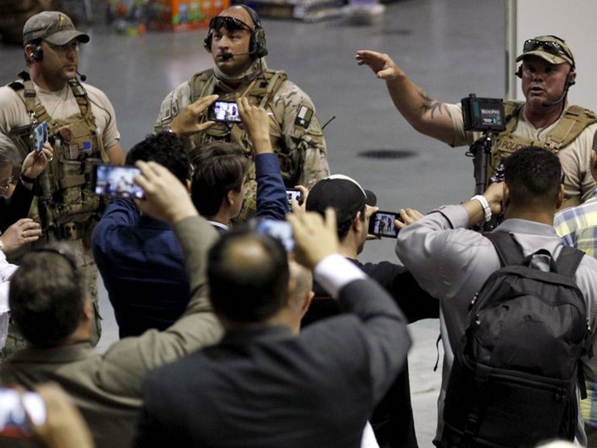 Police officers address attendees at the Muhammad Art Exhibit and Contest after they are prevented from leaving when shots were fired at the exhibit in Garland.