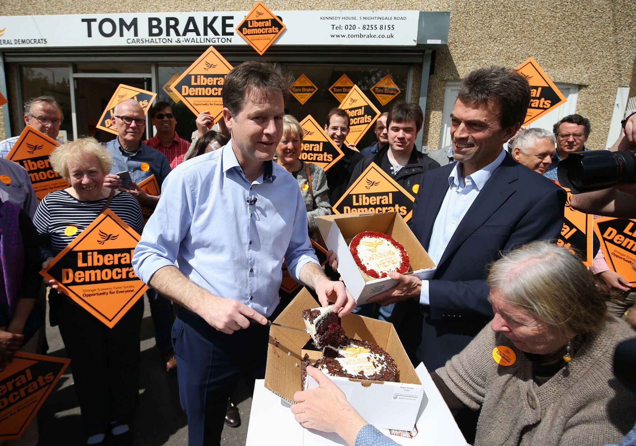 Nick Clegg hands out cake to Lib Dem activists on the campaign trail