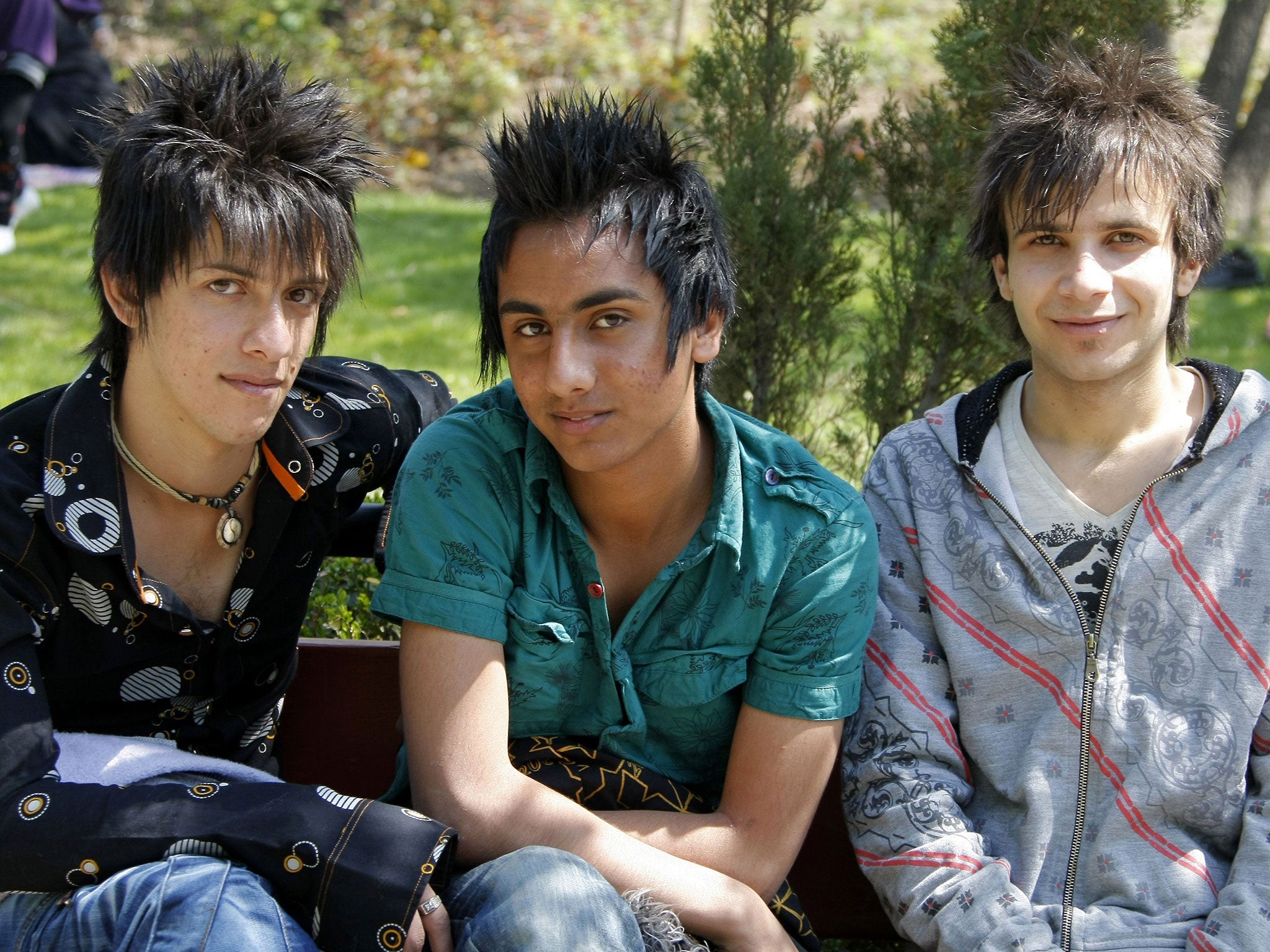A file picture taken in Tehran on 2 April, 2009, shows Iranian youths with spiky hair picnicking in a park