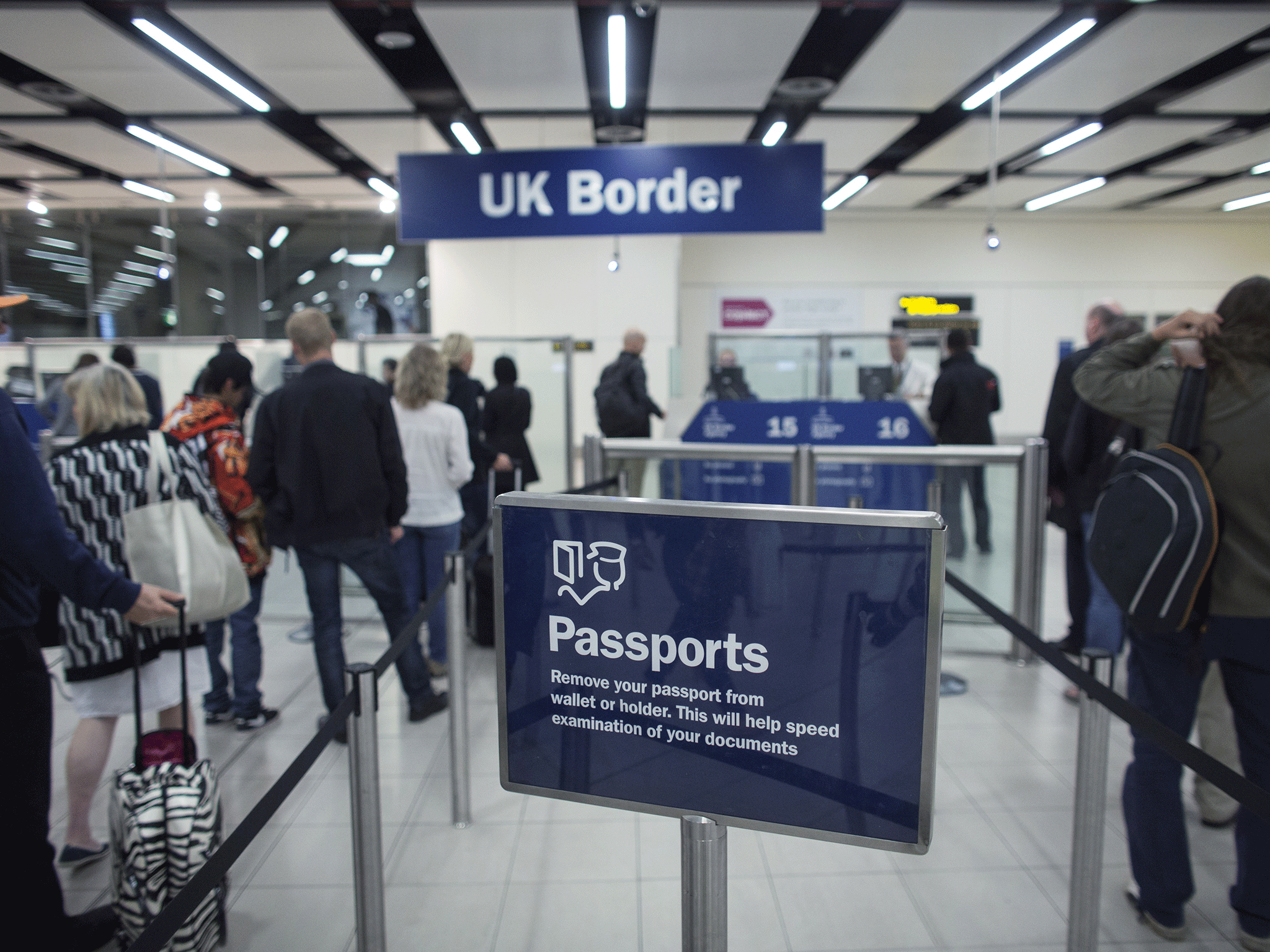 Border Force check the passports of passengers arriving at Gatwick Airport on May 28, 2014 in London