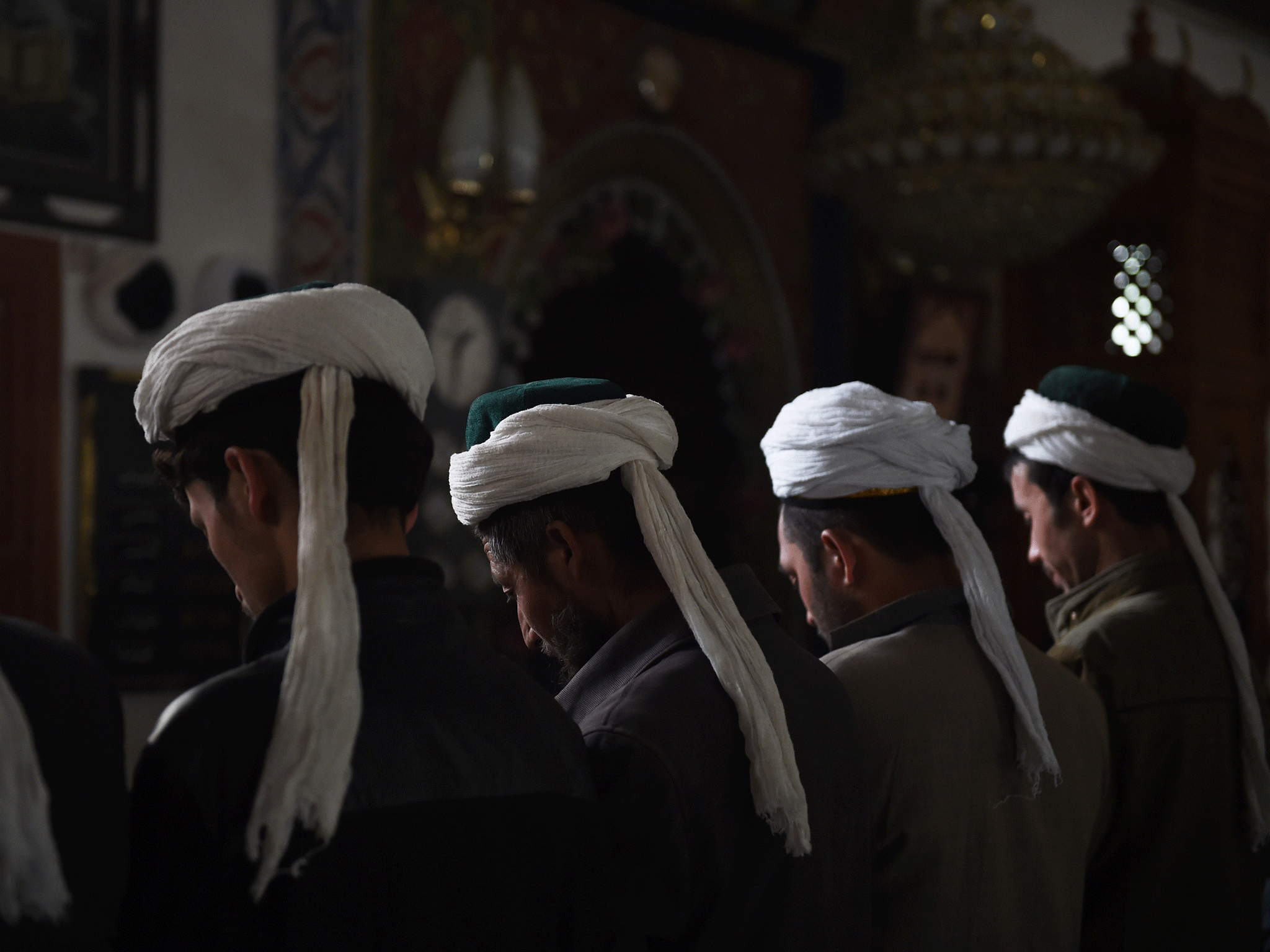 Uighur men praying in a mosque in Hotan, in China's western Xinjiang region, on 16 April, 2015