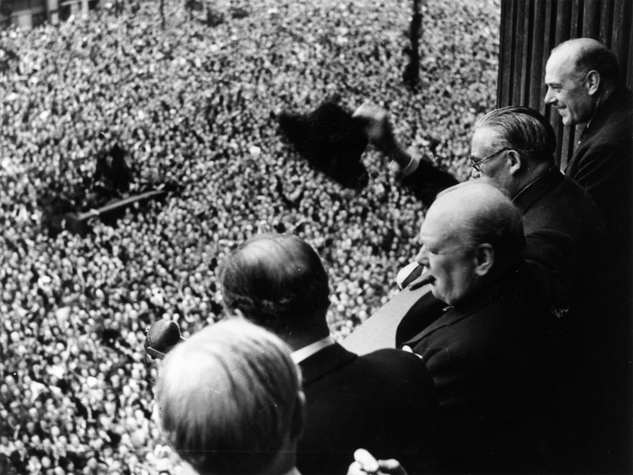 Winston Churchill waves to the crowds in Whitehall (Getty)