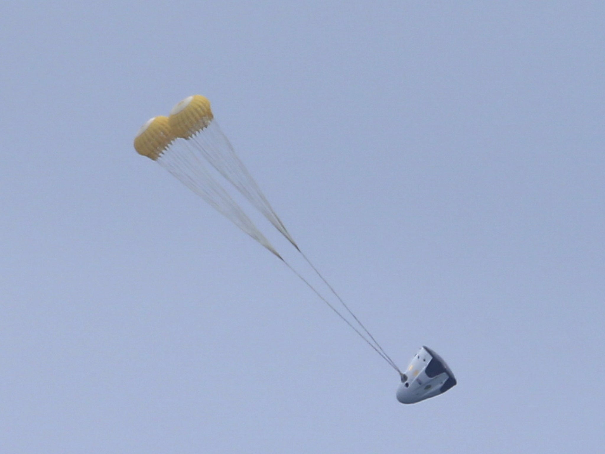 The unmanned SpaceX Crew Dragon lands after lifting off from launch pad 40 during a Pad Abort Test at the Cape Canaveral Air Force Station in Cape Canaveral, Florida May 6, 2015