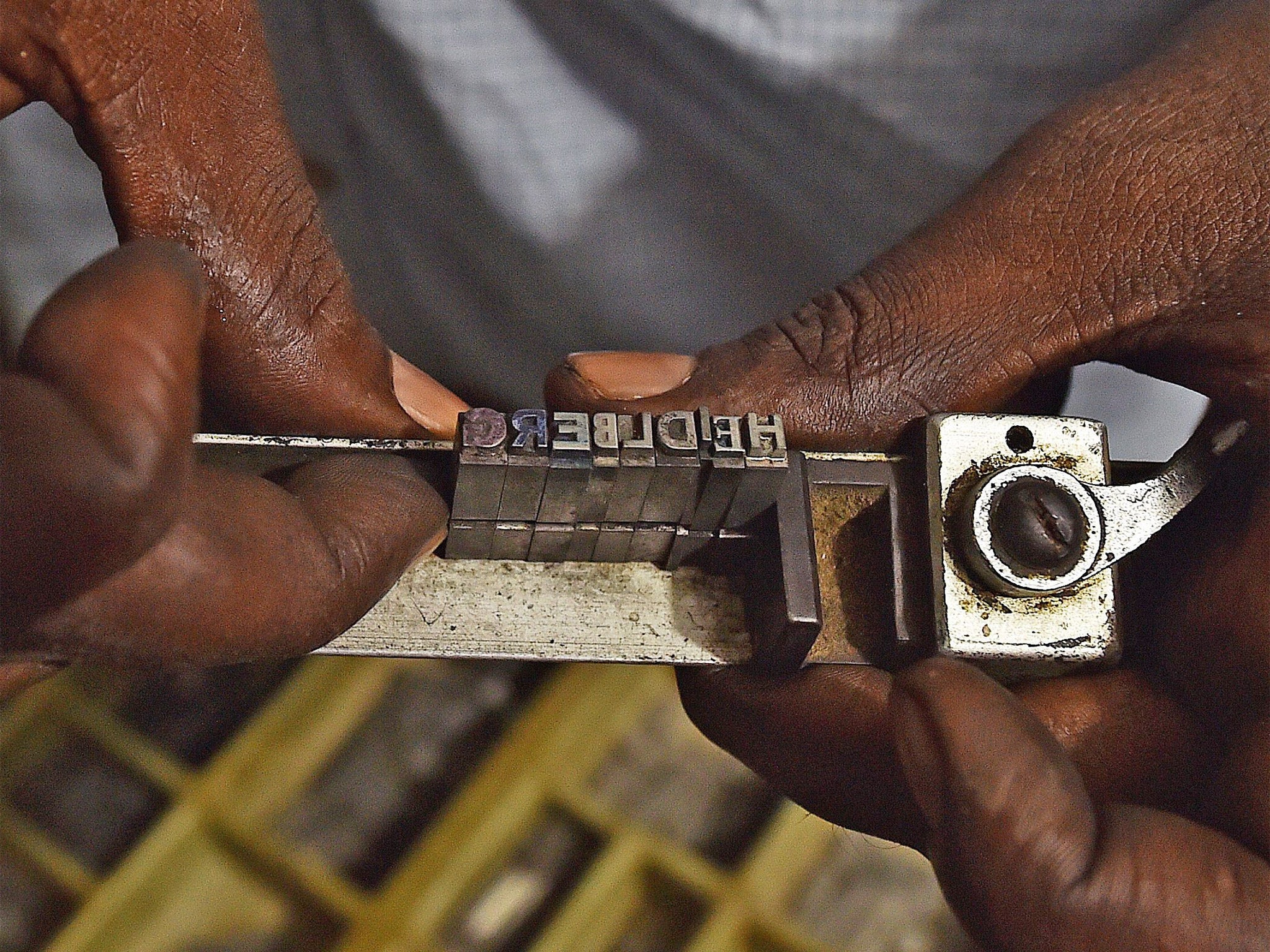 Loading individual letters on to an original Heidelberg printing press