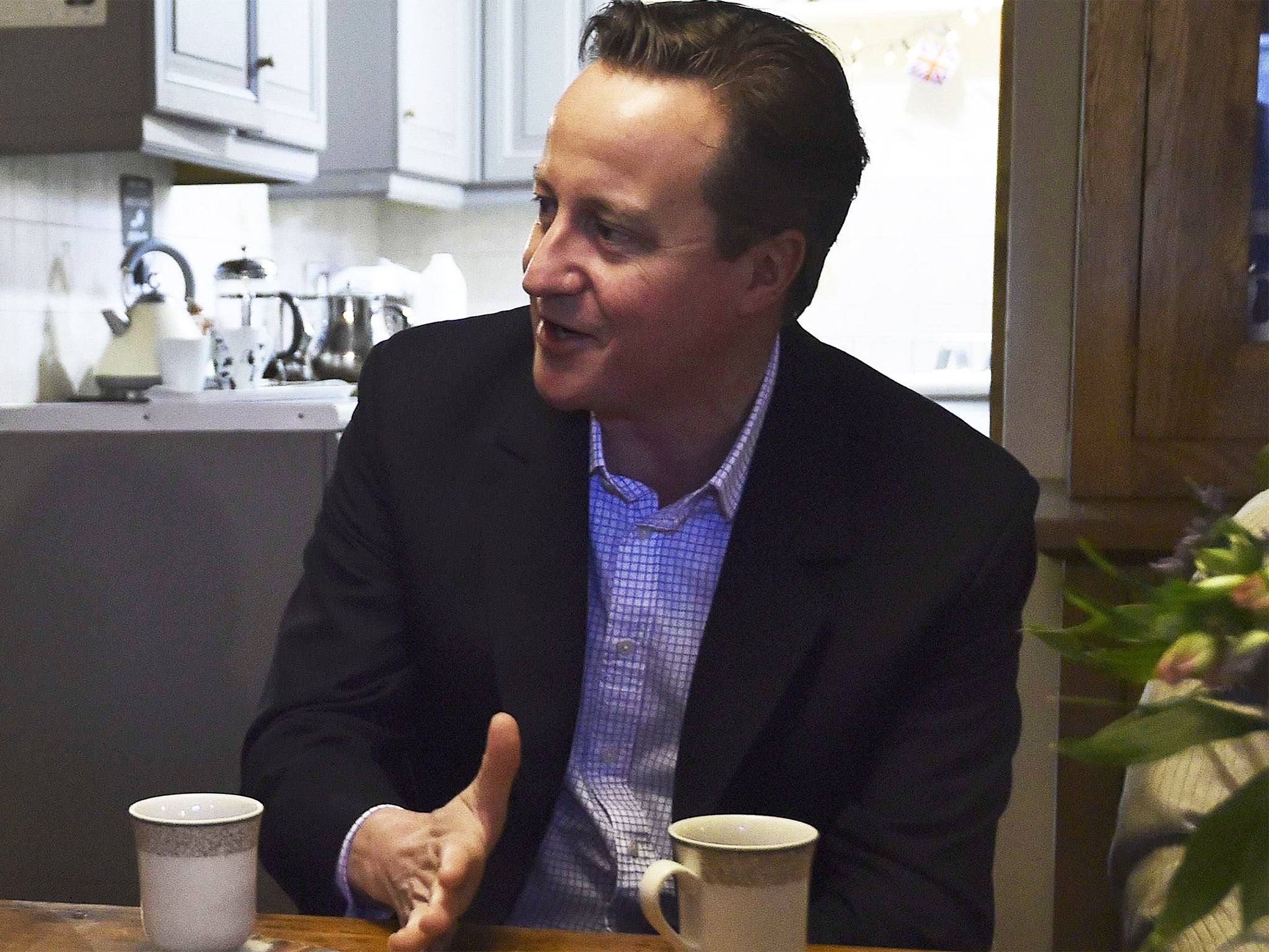 David Cameron speaks with local farmers during a campaign visit near Brecon in Wales