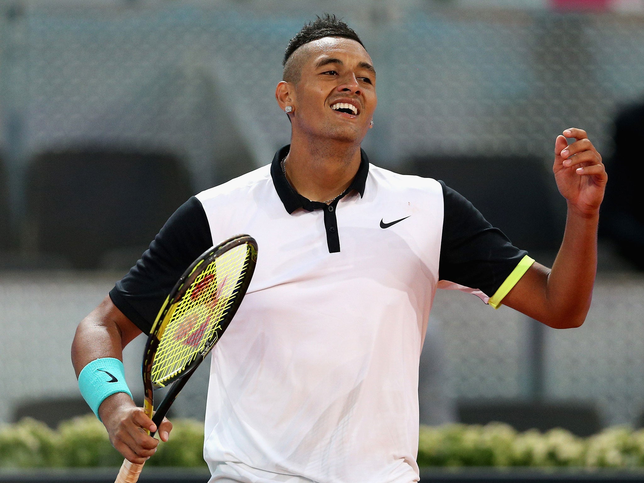 Nick Kyrgios celebrates his victory over Roger Federer