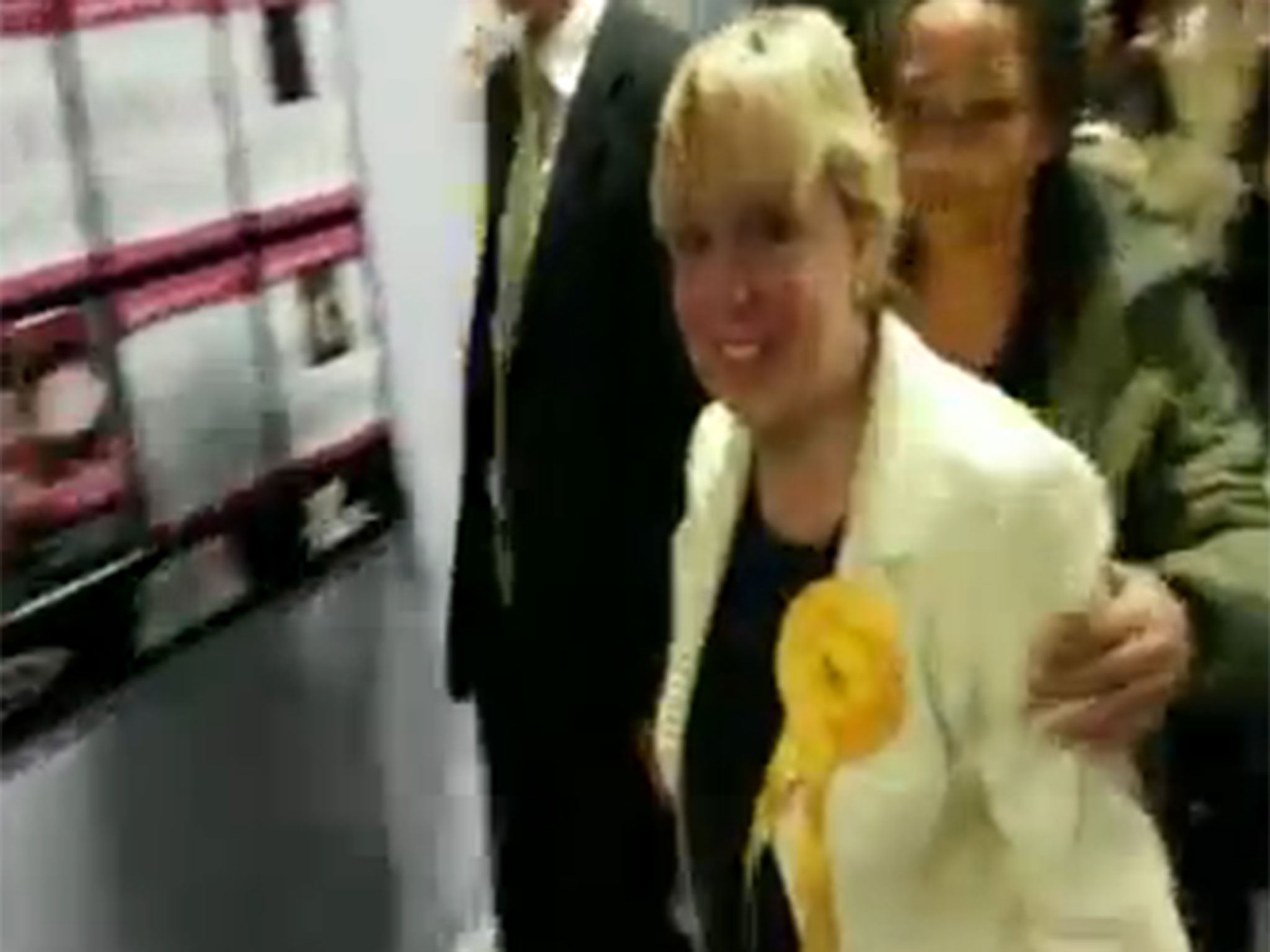 Lorely Burt supporter pushes away camera