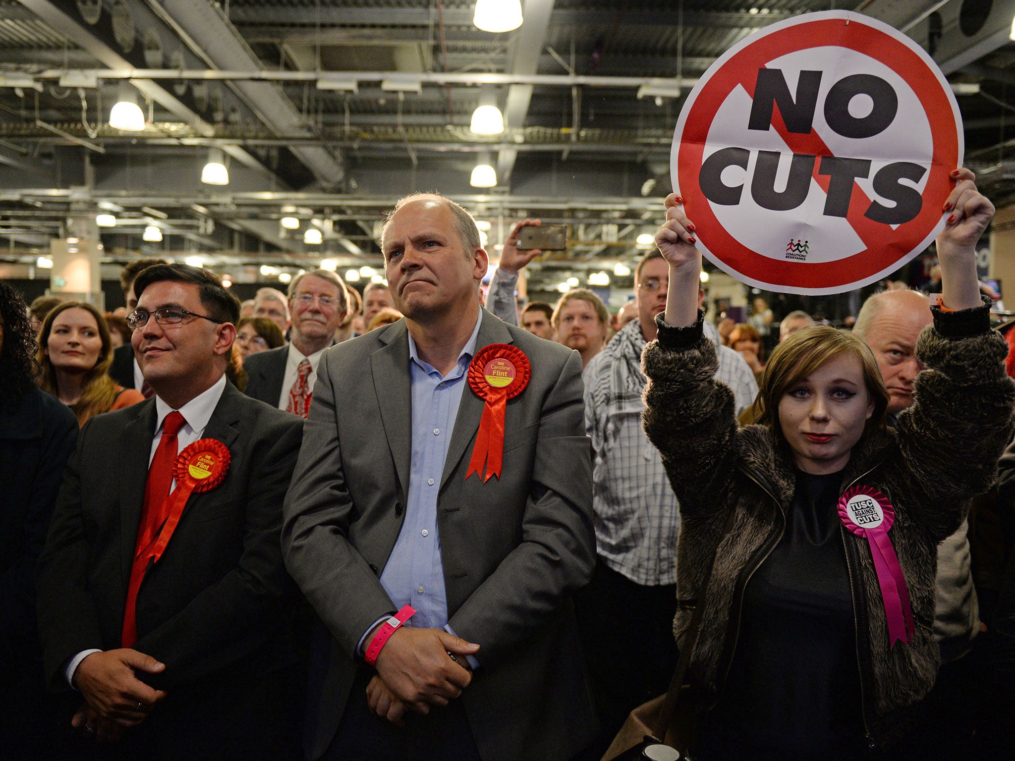 Labour Party supporters listen as Leader of the opposition Labour Party Ed Miliband gives a speech after retaining his seat of Doncaster North at the counting centre at Doncaster Racecourse