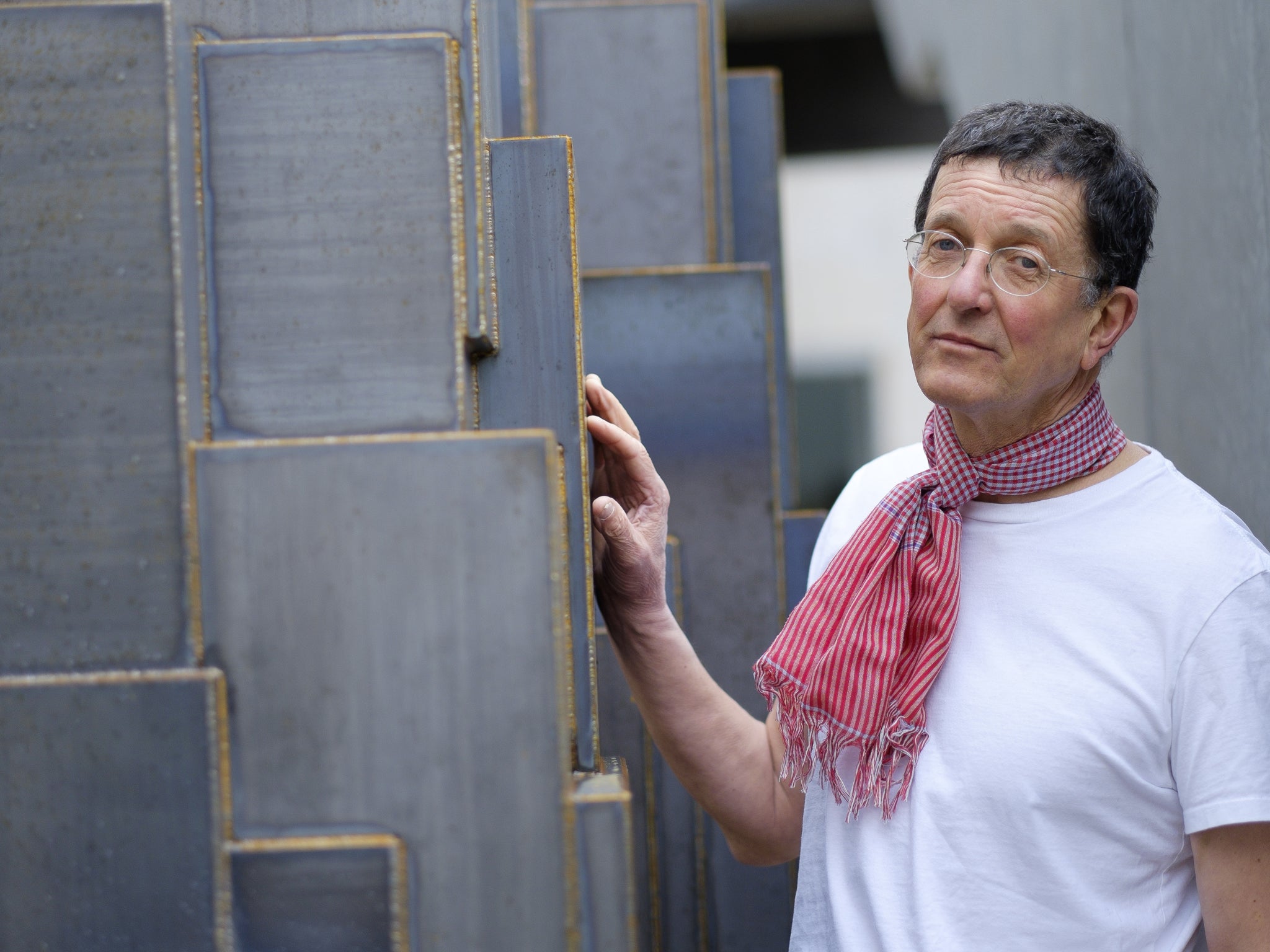 Sculptor Antony Gormley, beside a sculpture at his studio in Kings Cross, London