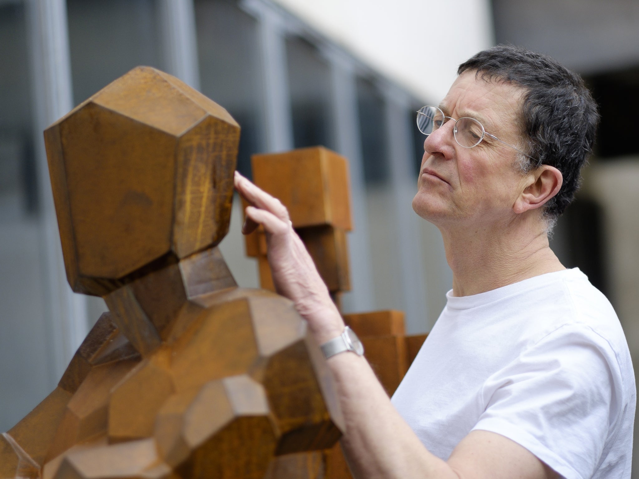 Sculptor Antony Gormley, checks the surface of a sculpture entitled "Check", at his studio in Kings Cross, London