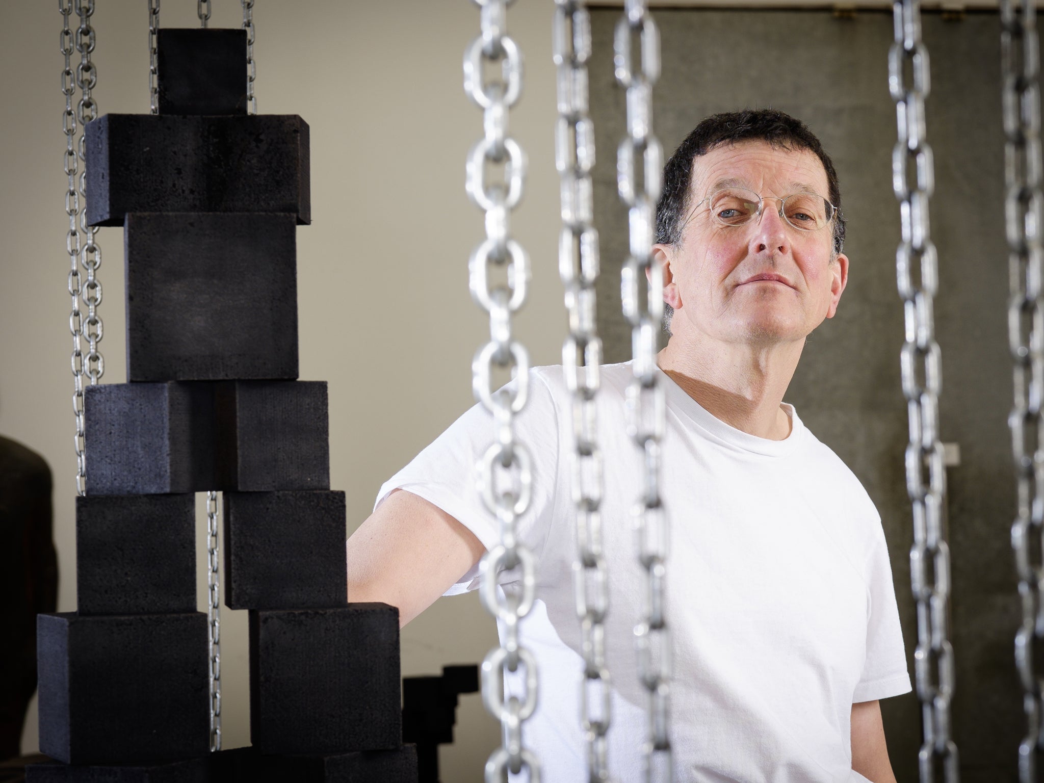 Sculptor Antony Gormley, beside a sculpture entitled "Strike", in his studio in Kings Cross, London